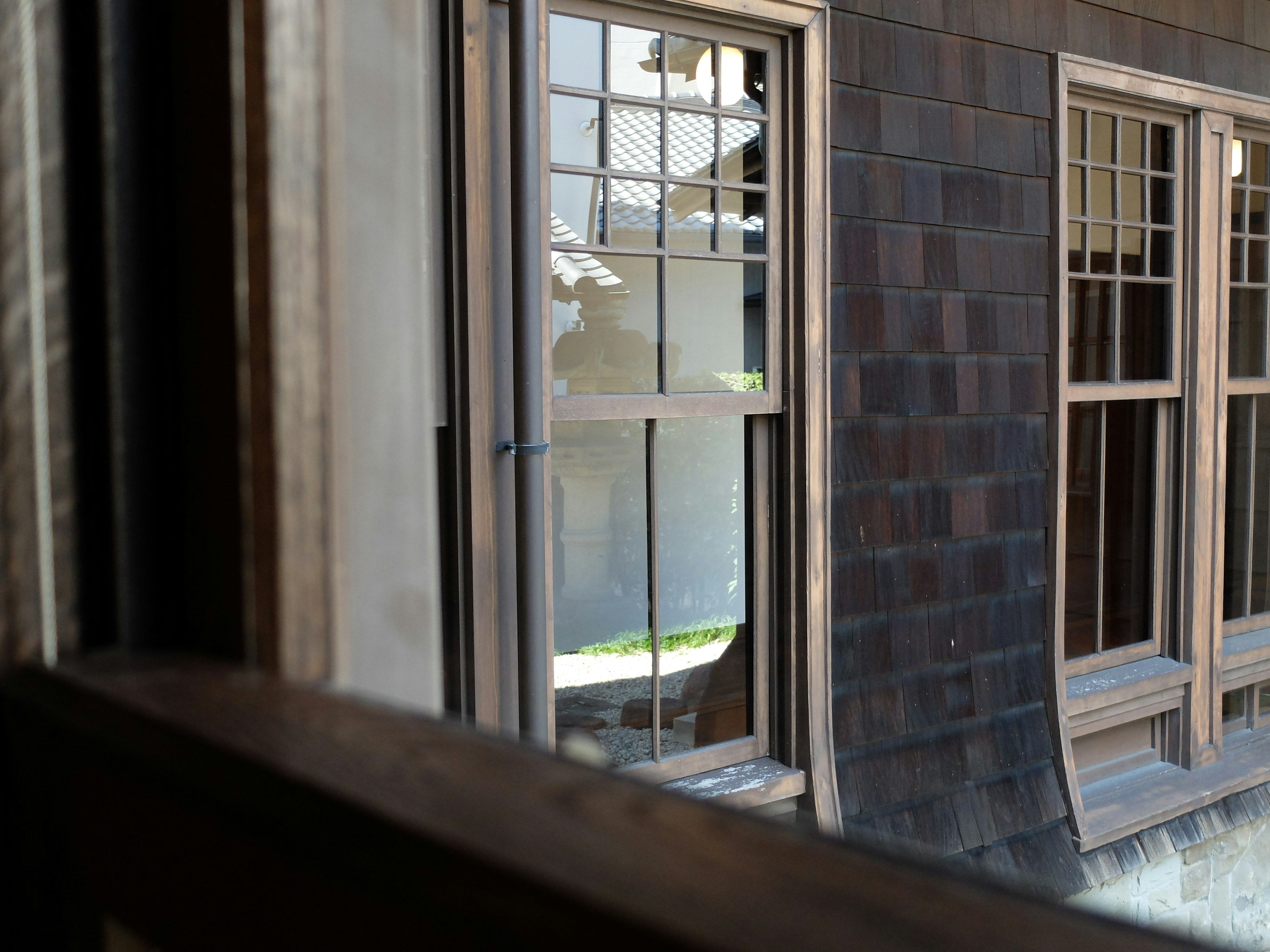 View of wooden window frames overlooking a quiet courtyard