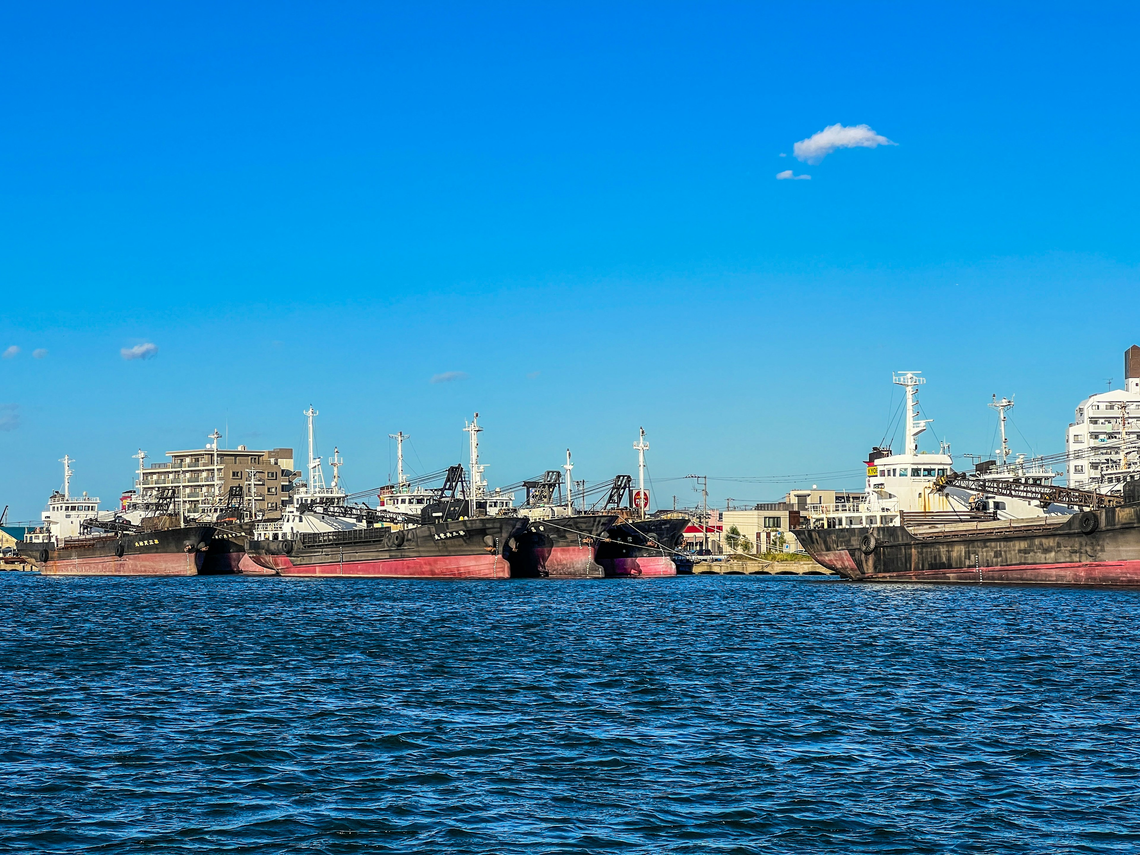 Docked ships with a clear blue sky and waterfront