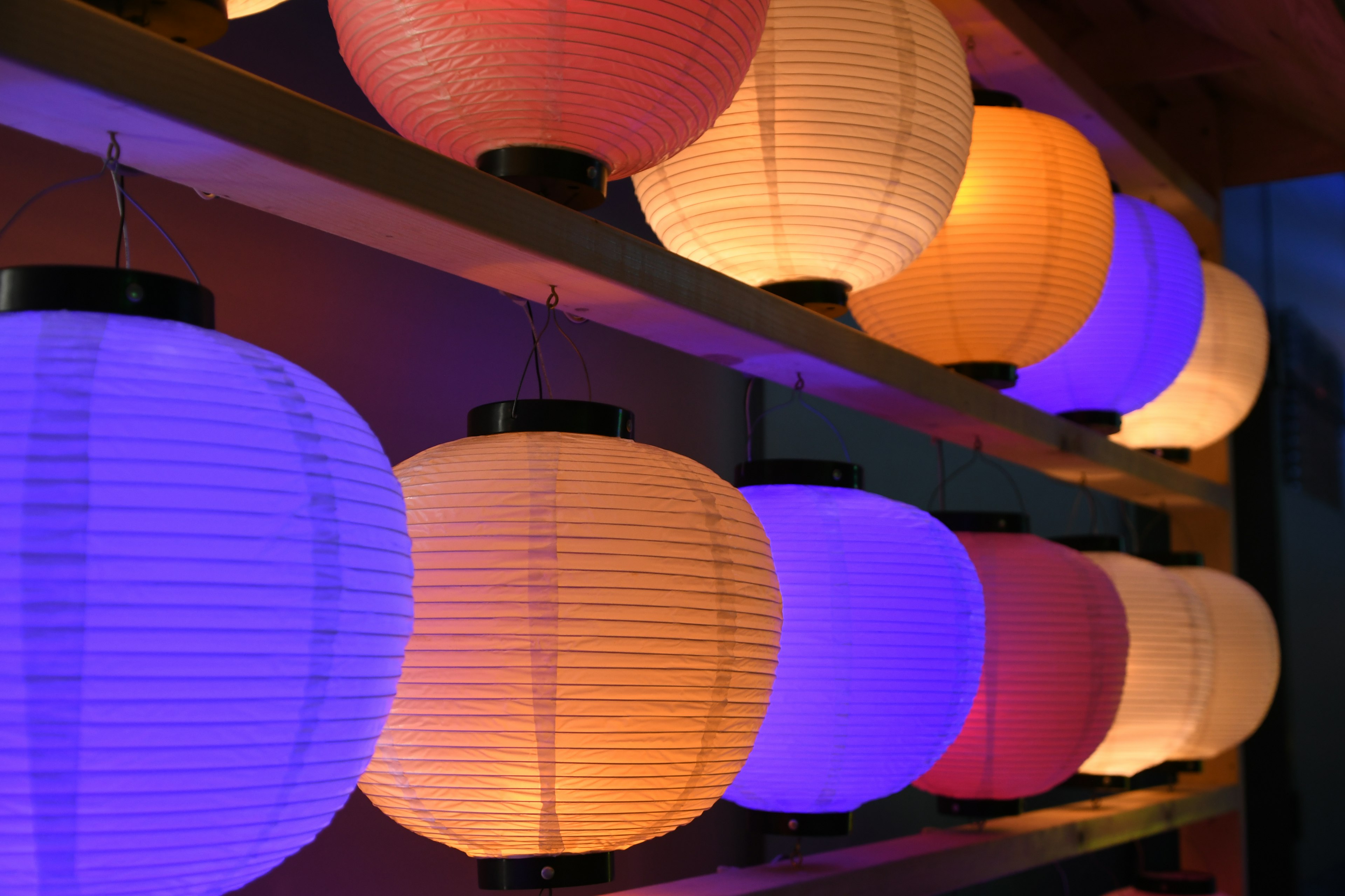 Colorful lanterns arranged in a row with vibrant lighting