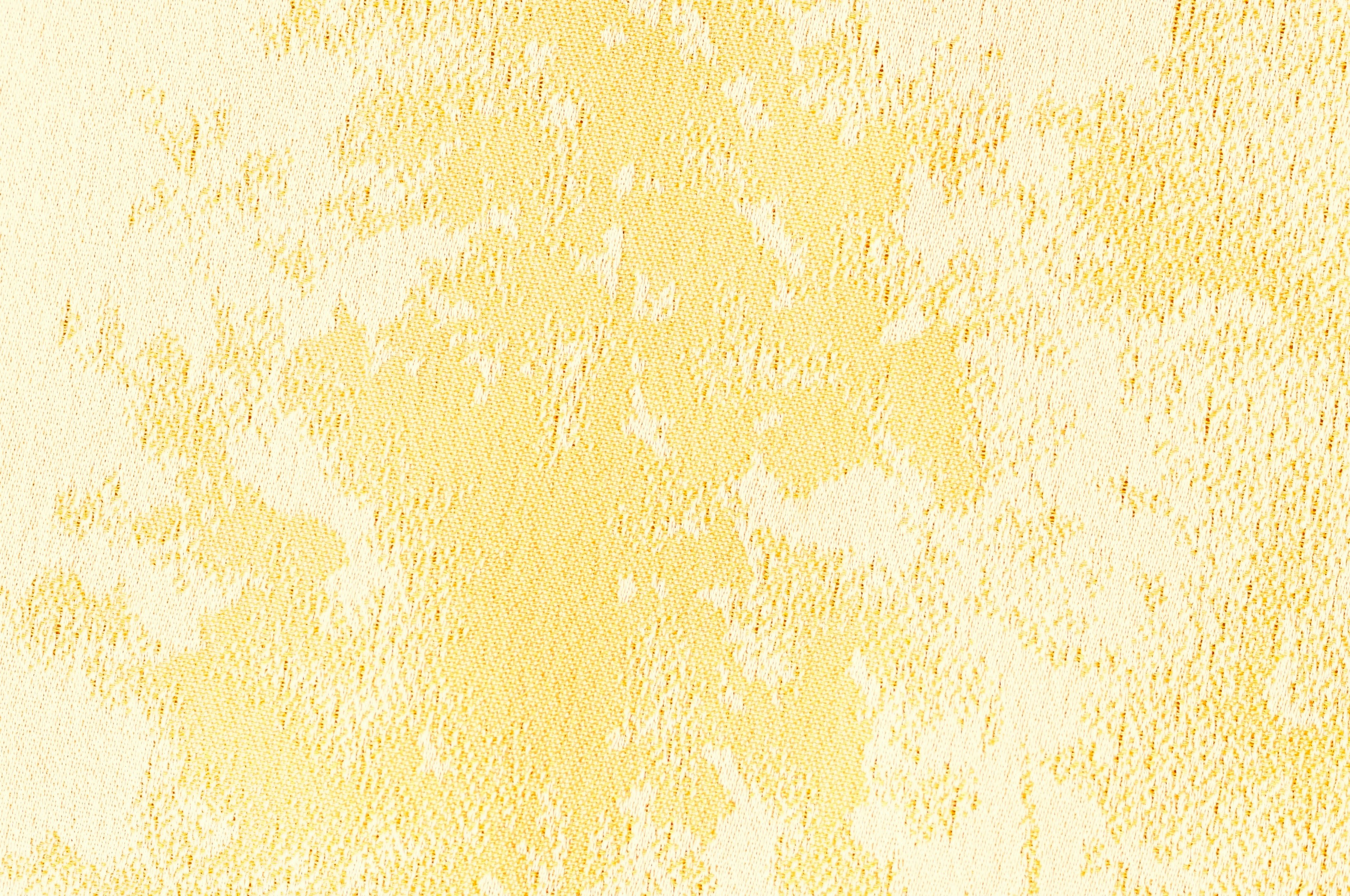 Soft yellow textured wall with natural patterns