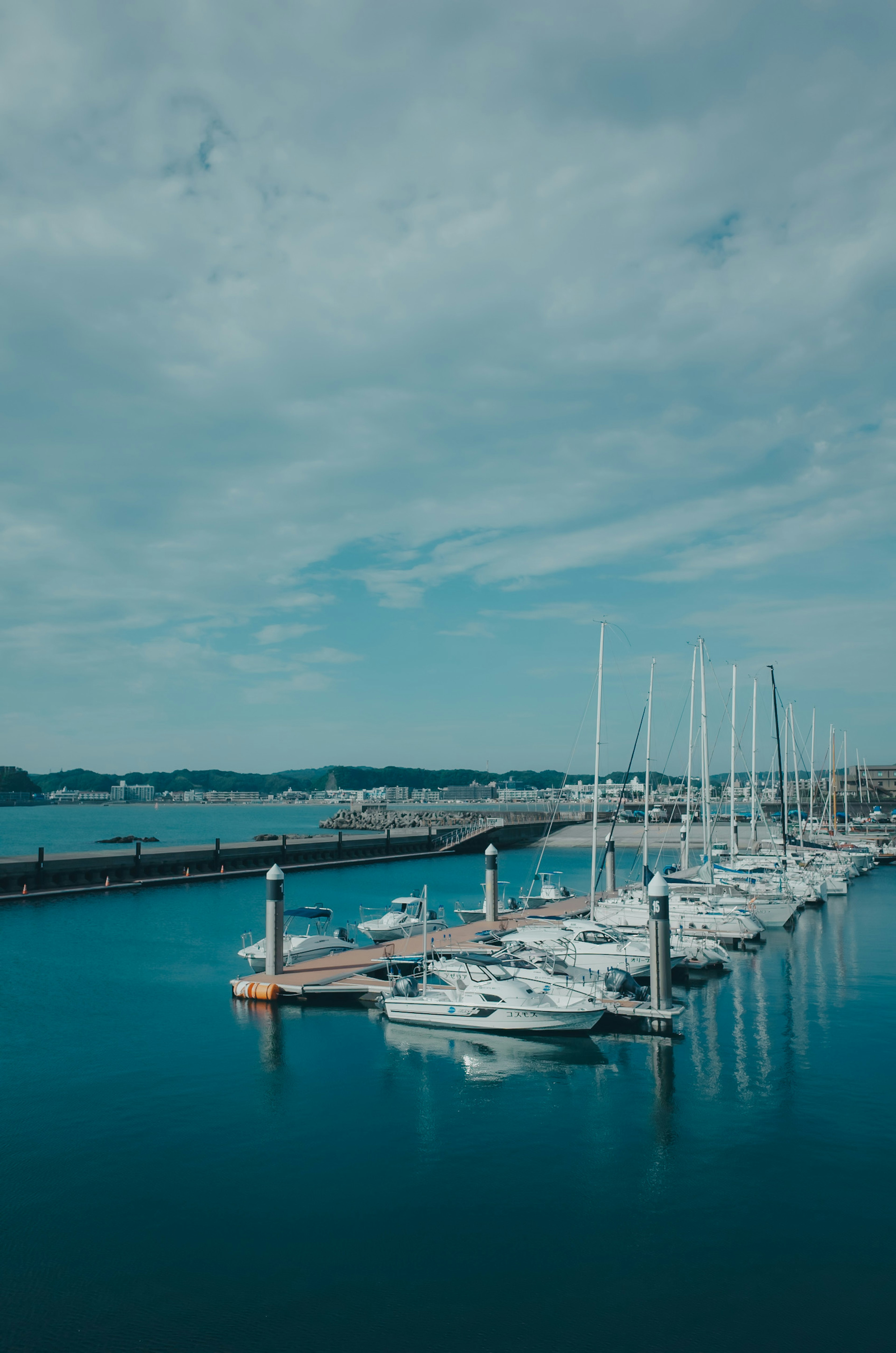 Serene harbor with white yachts docked in blue water