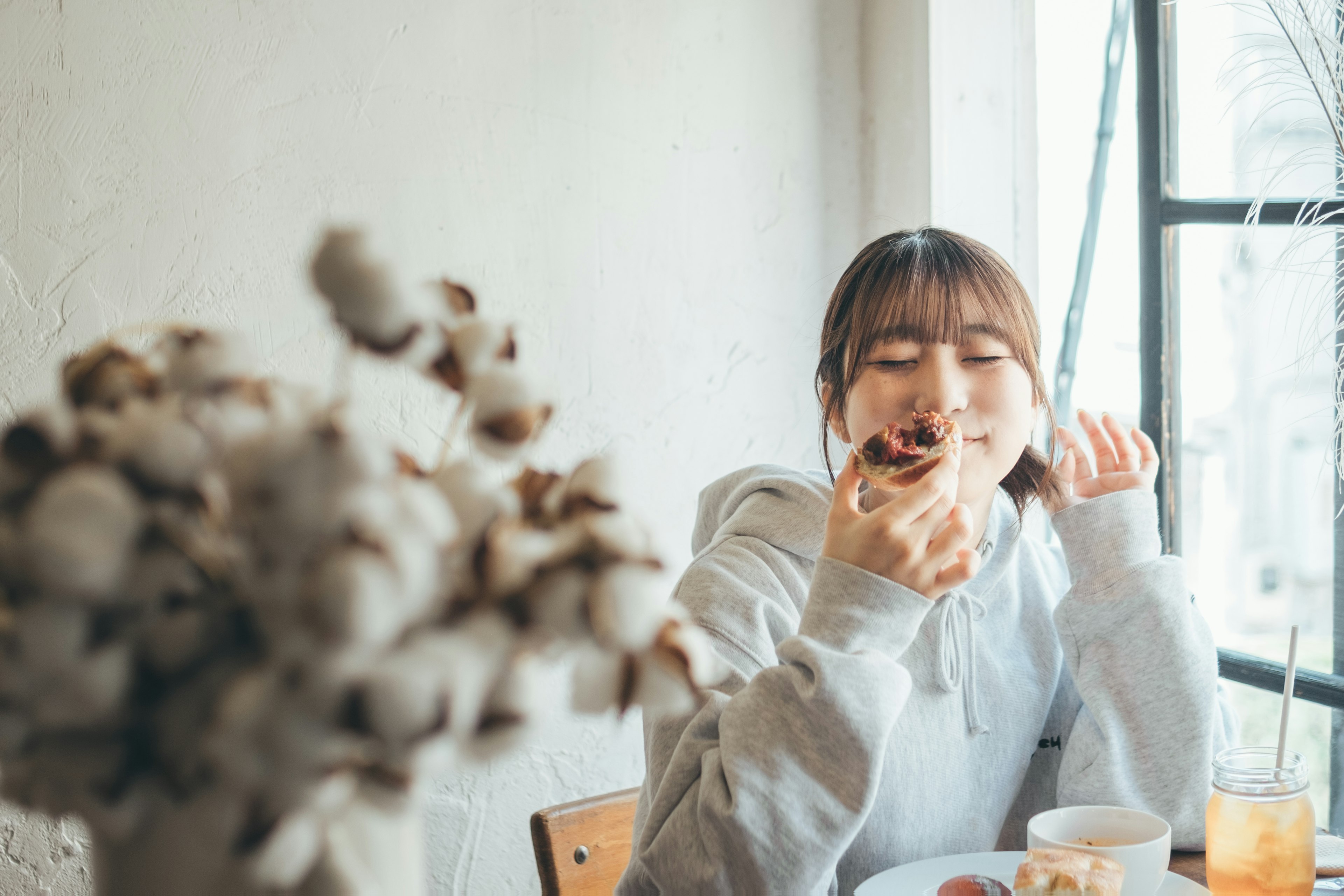 Woman enjoying a snack in a cafe with a smile