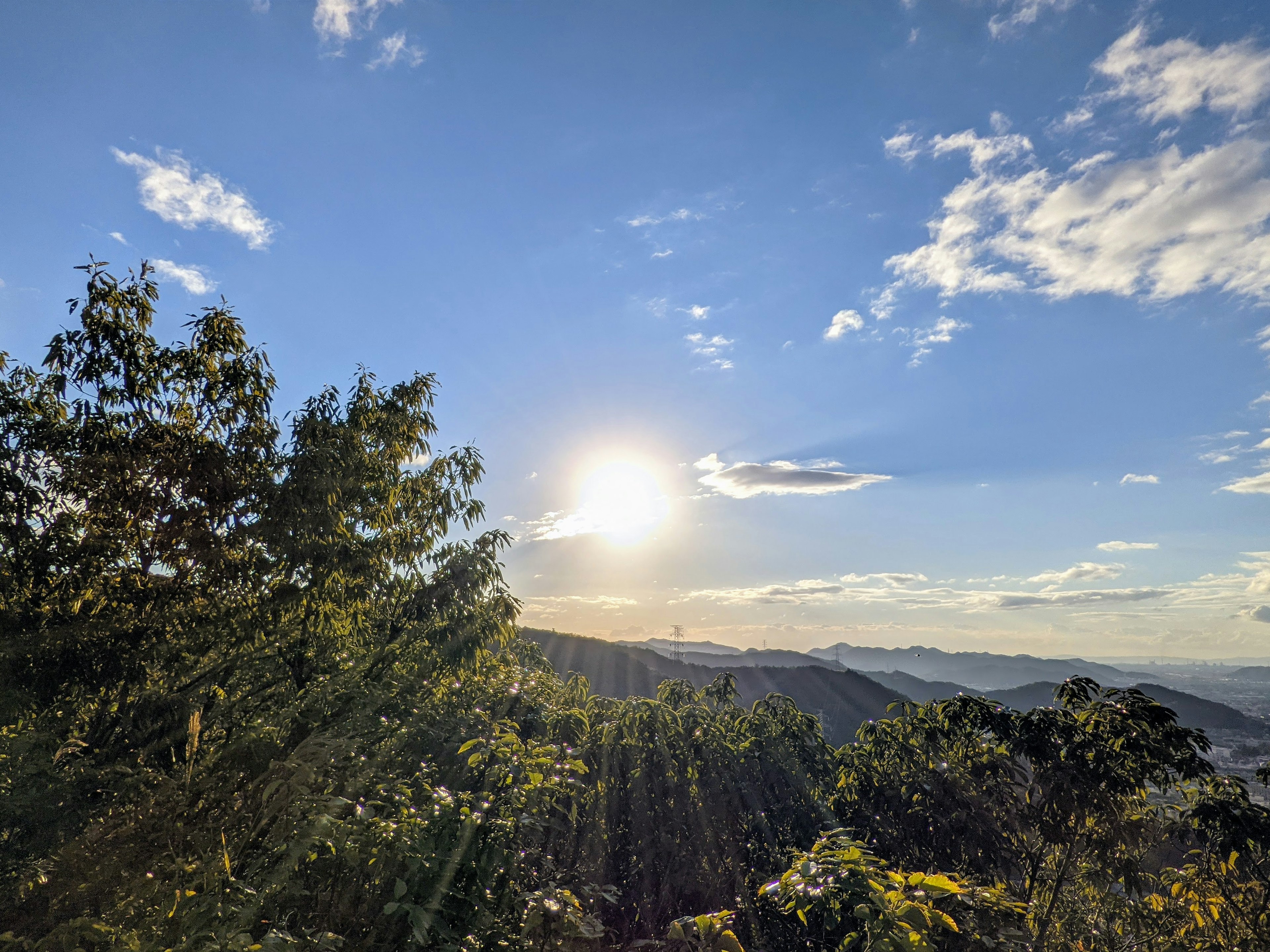 Scenic view of mountains under blue sky with sunlight