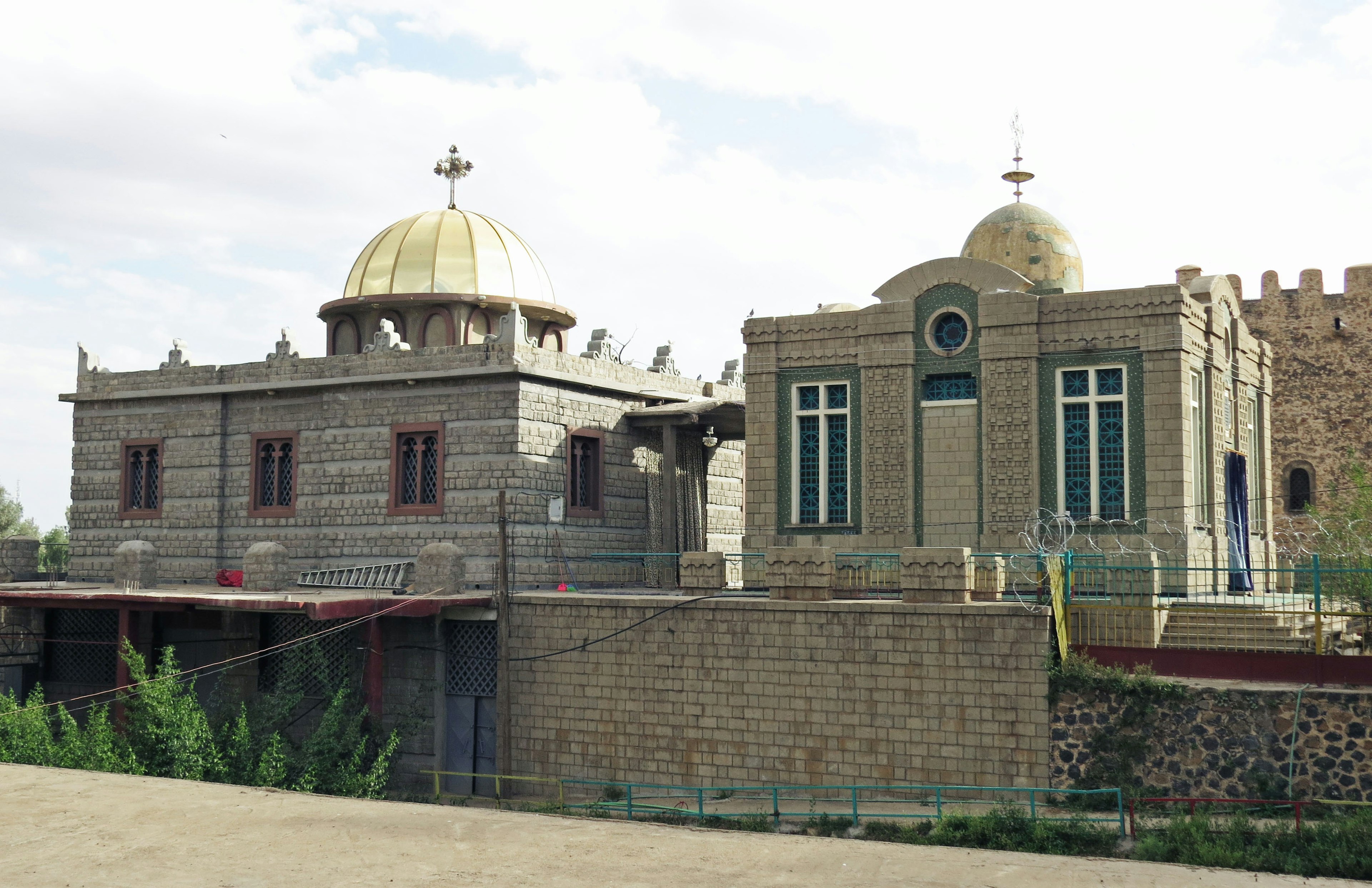 Ethiopian church building featuring a golden dome and stone walls