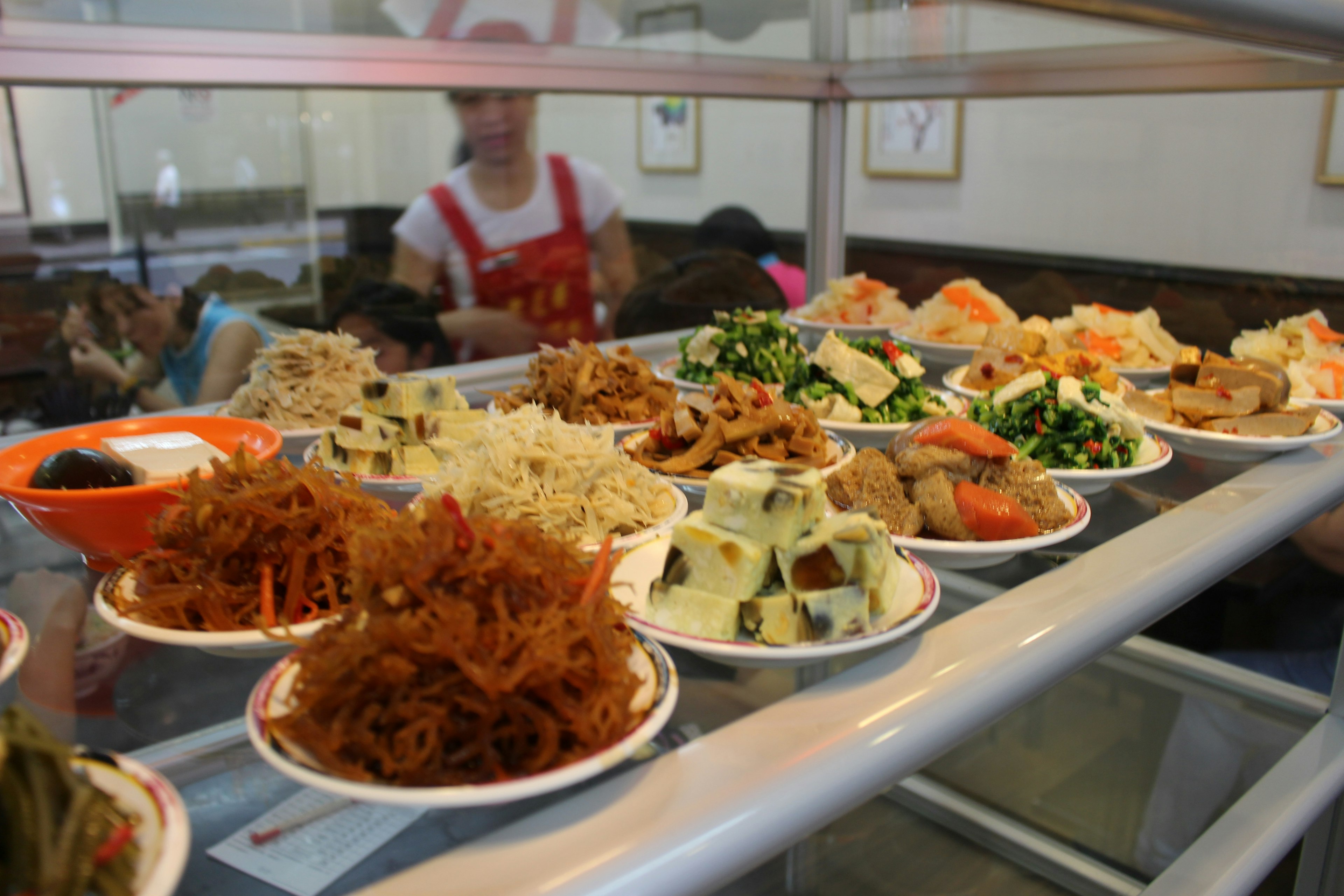 Counter filled with colorful dishes in a cafeteria