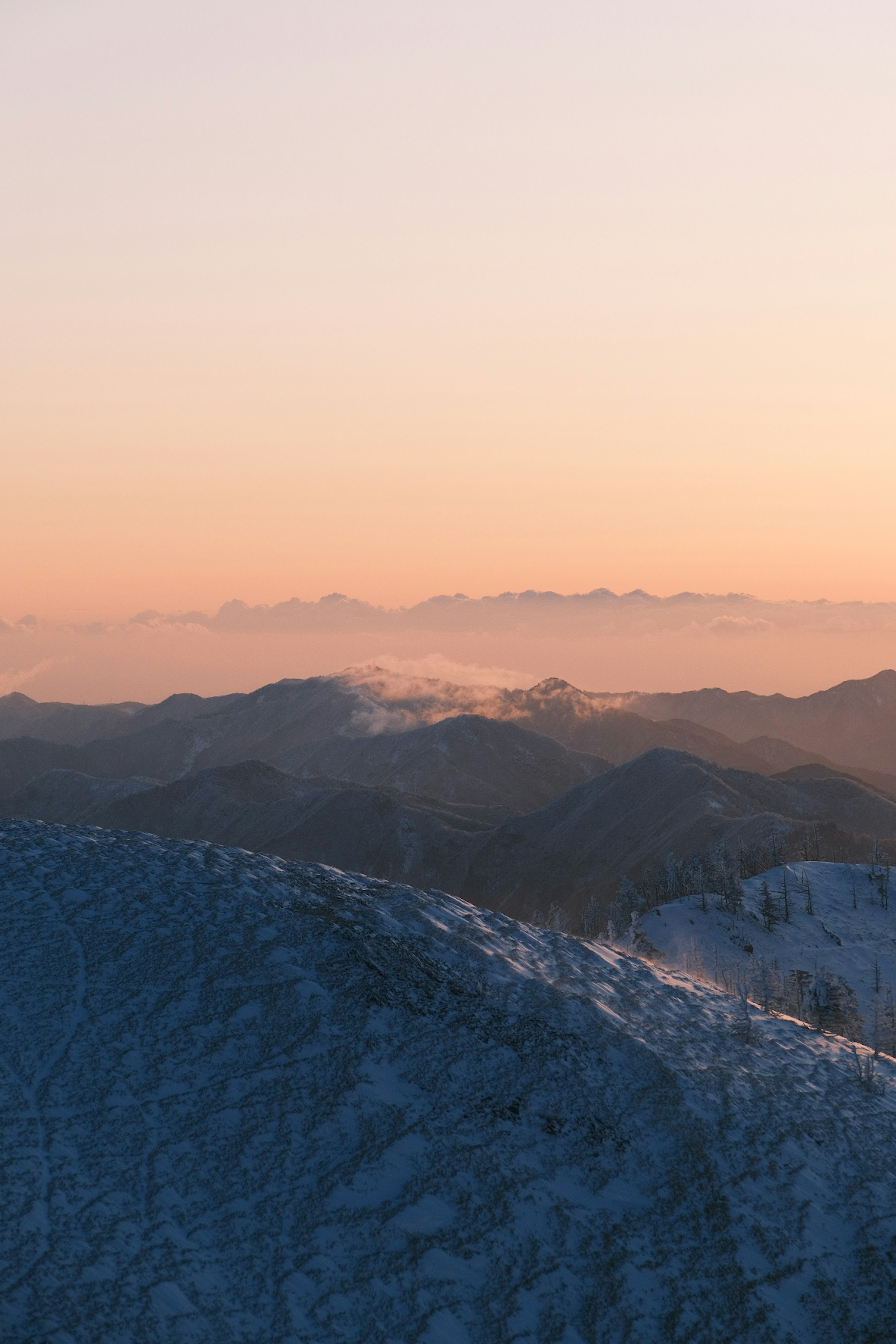 雪に覆われた山々と朝焼けの空の風景