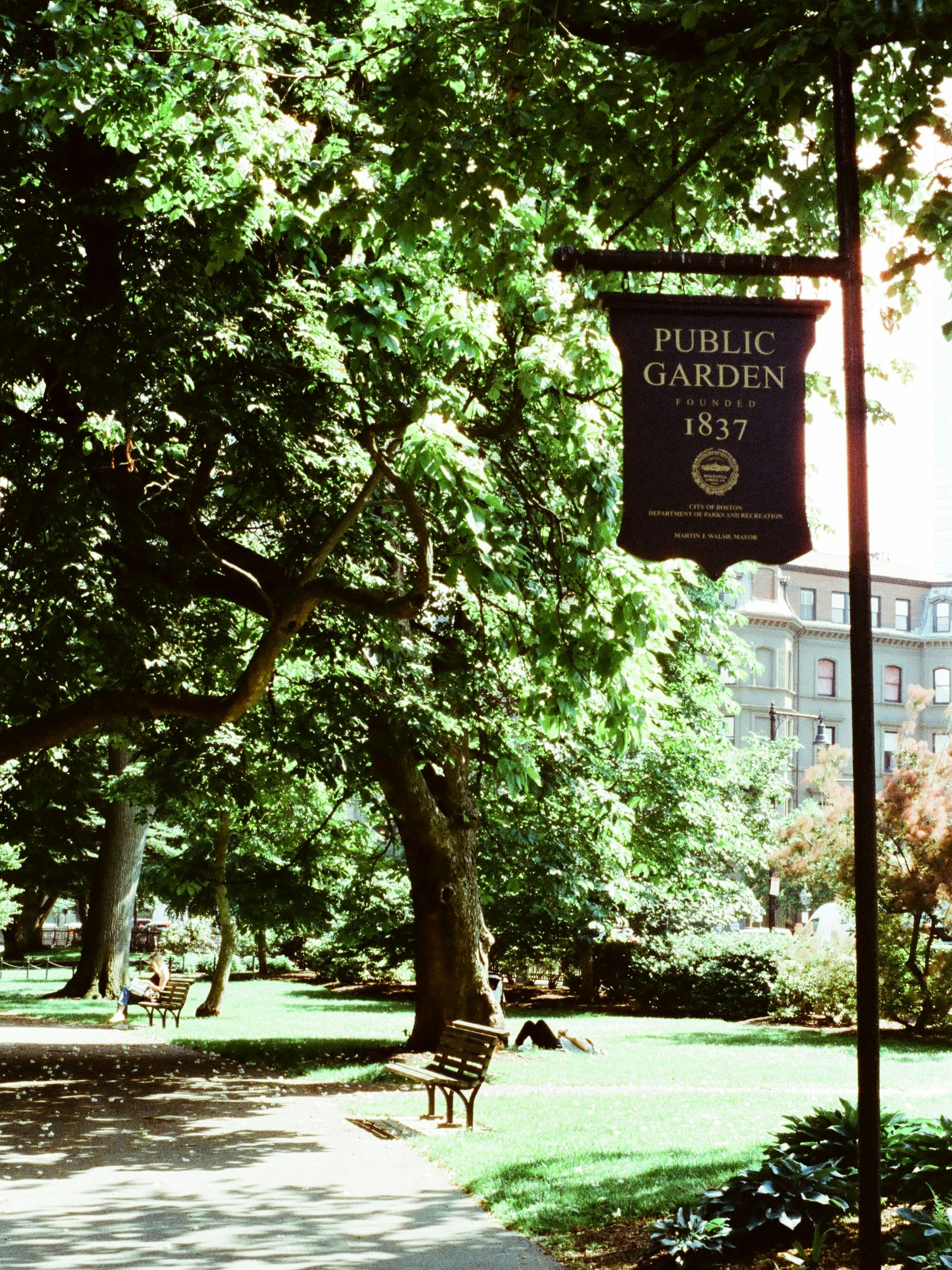 Public Garden sign with lush greenery and trees