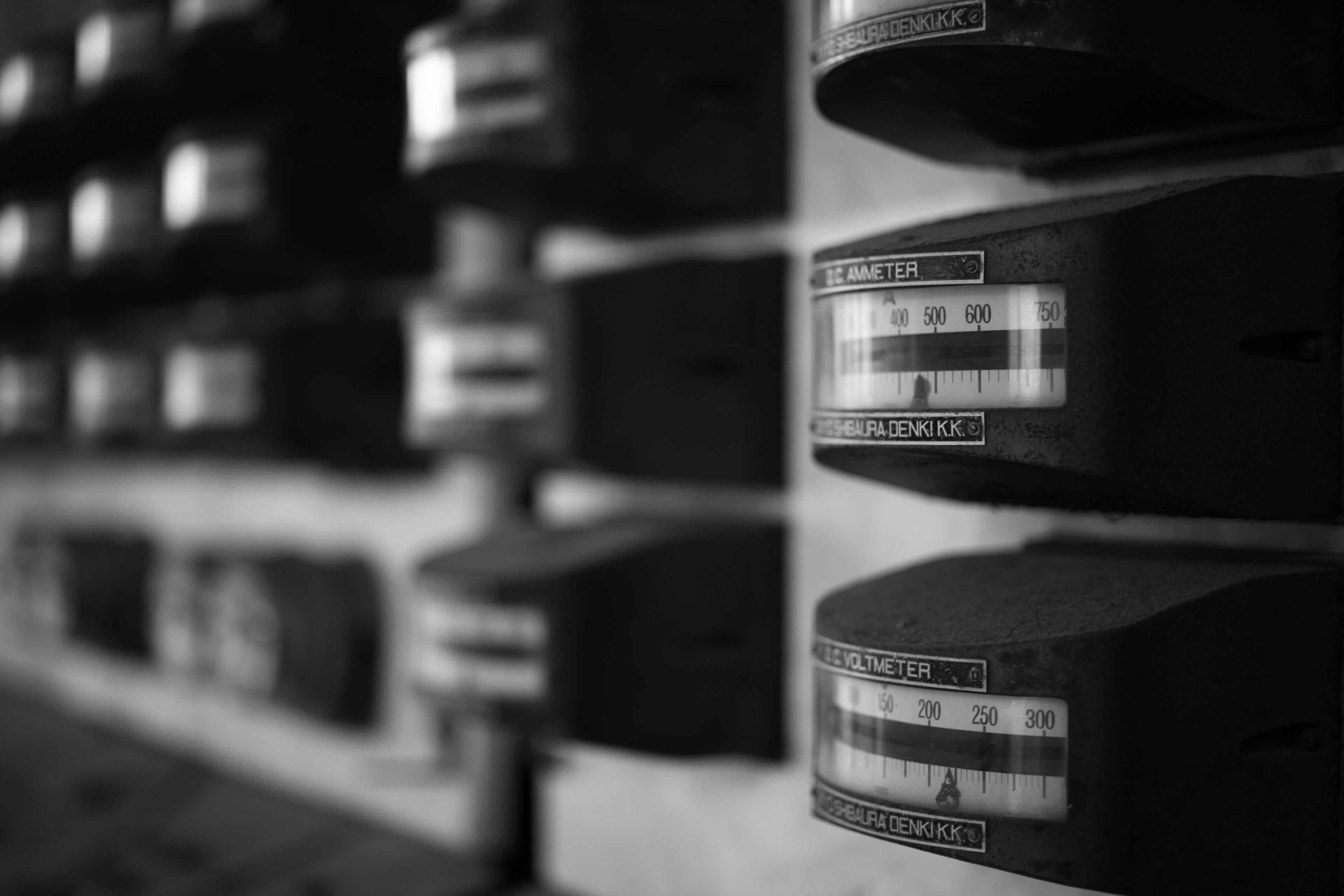 Close-up of black and white meters arranged on a wall