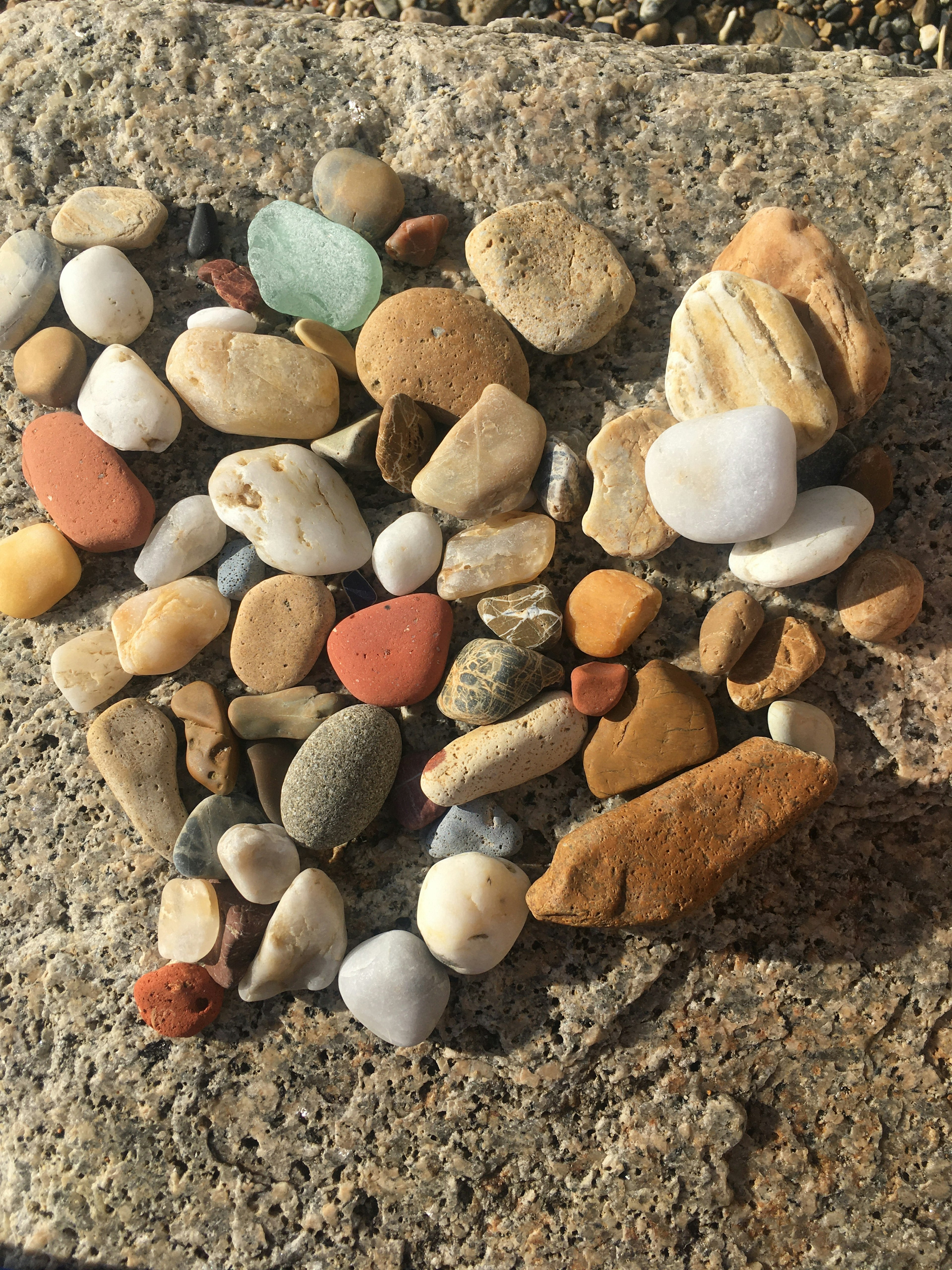 Colorful pebbles arranged in a heart shape