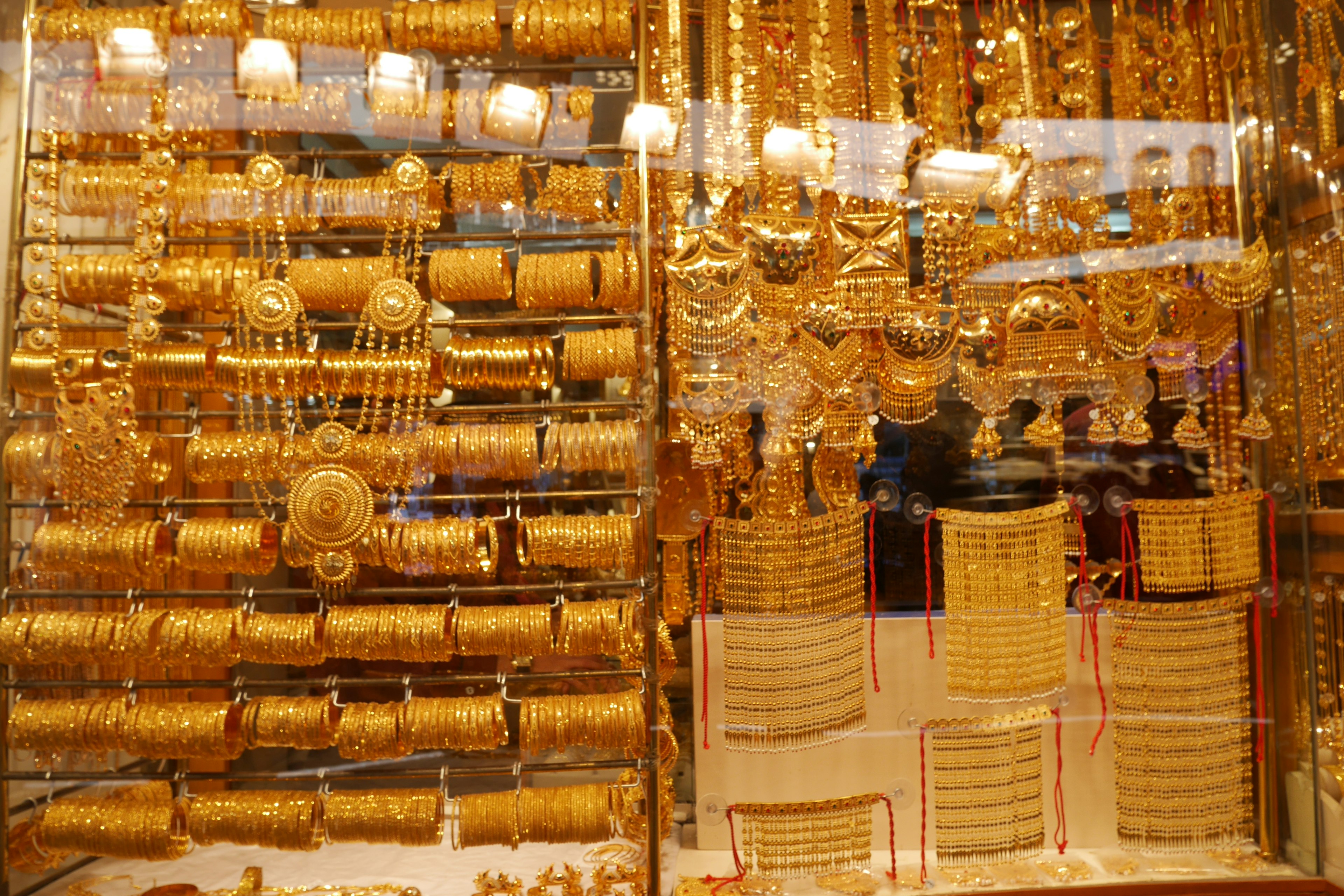 Display of various gold jewelry in a shop window