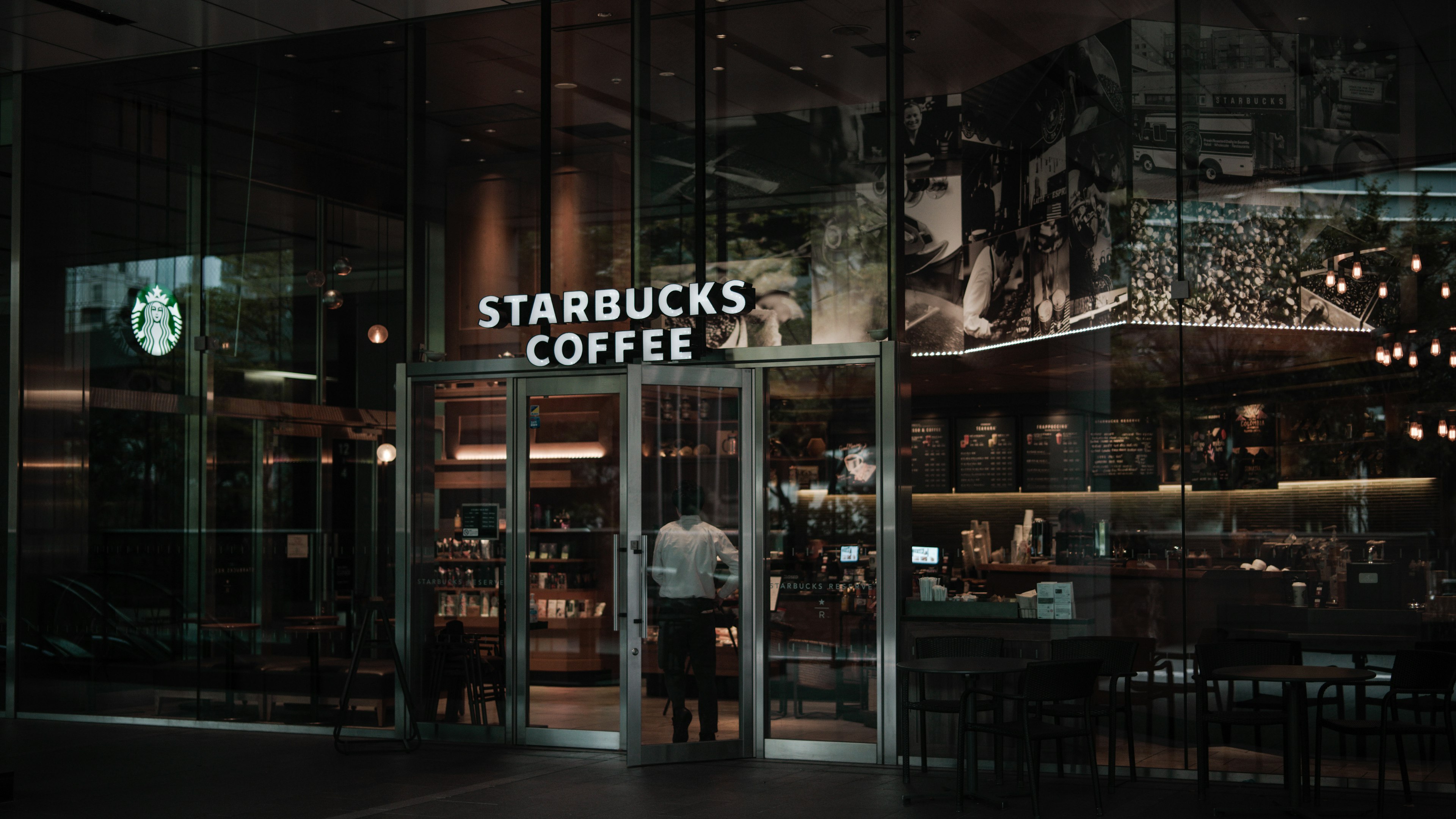 มุมมองภายนอกของร้านกาแฟ Starbucks ในบรรยากาศที่มีแสงน้อย