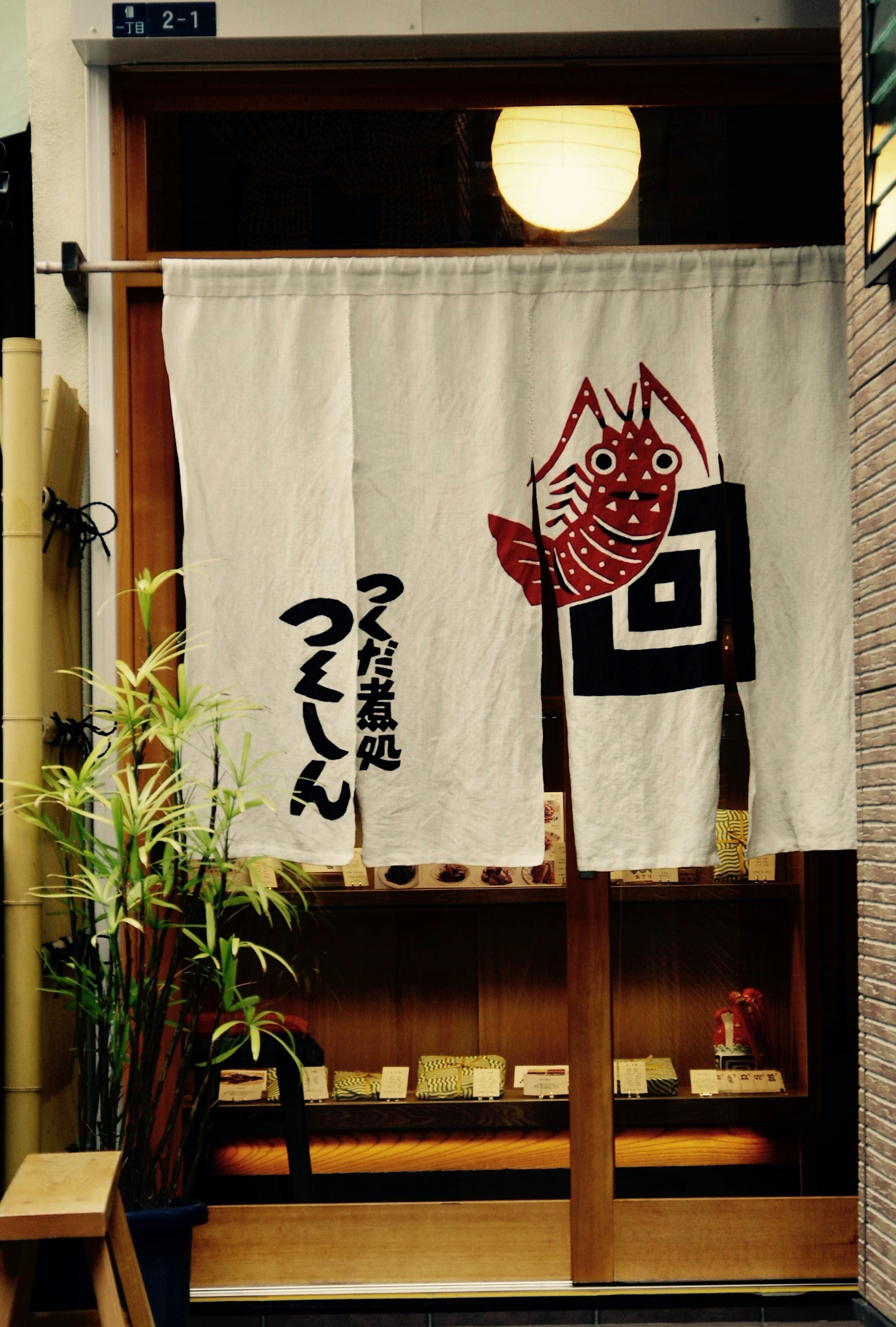 Rideau d'entrée avec un design de crevette rouge et le nom du magasin Tsukushin