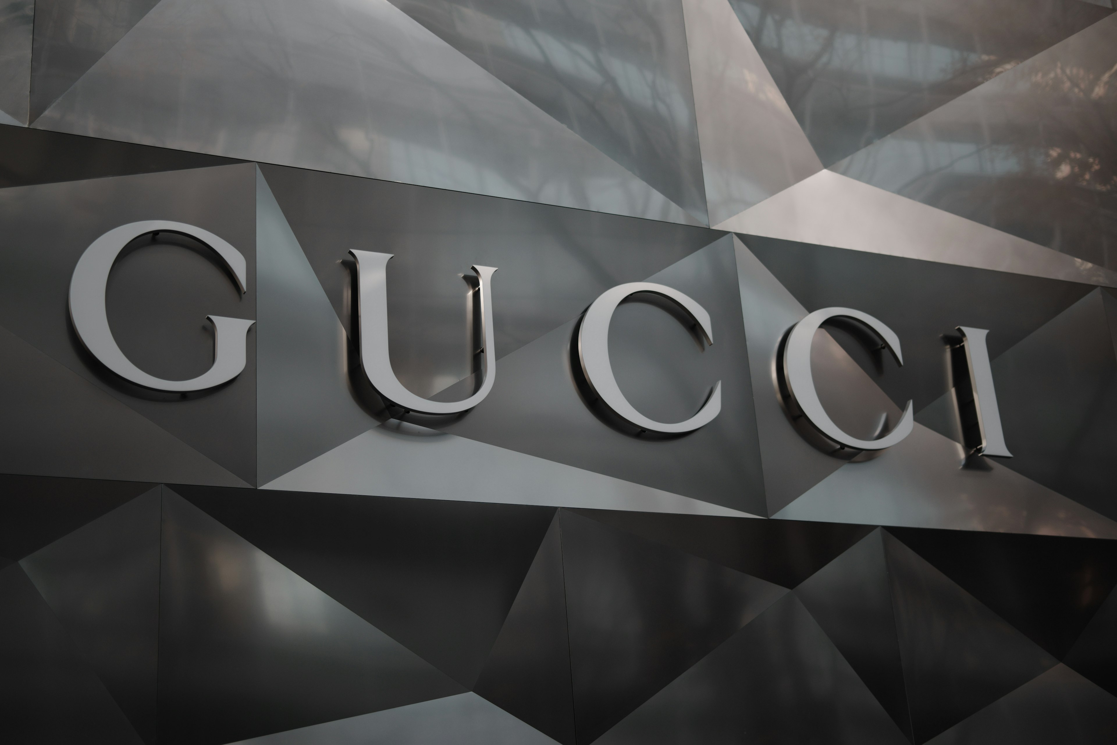 Gucci logo prominently displayed on a textured background