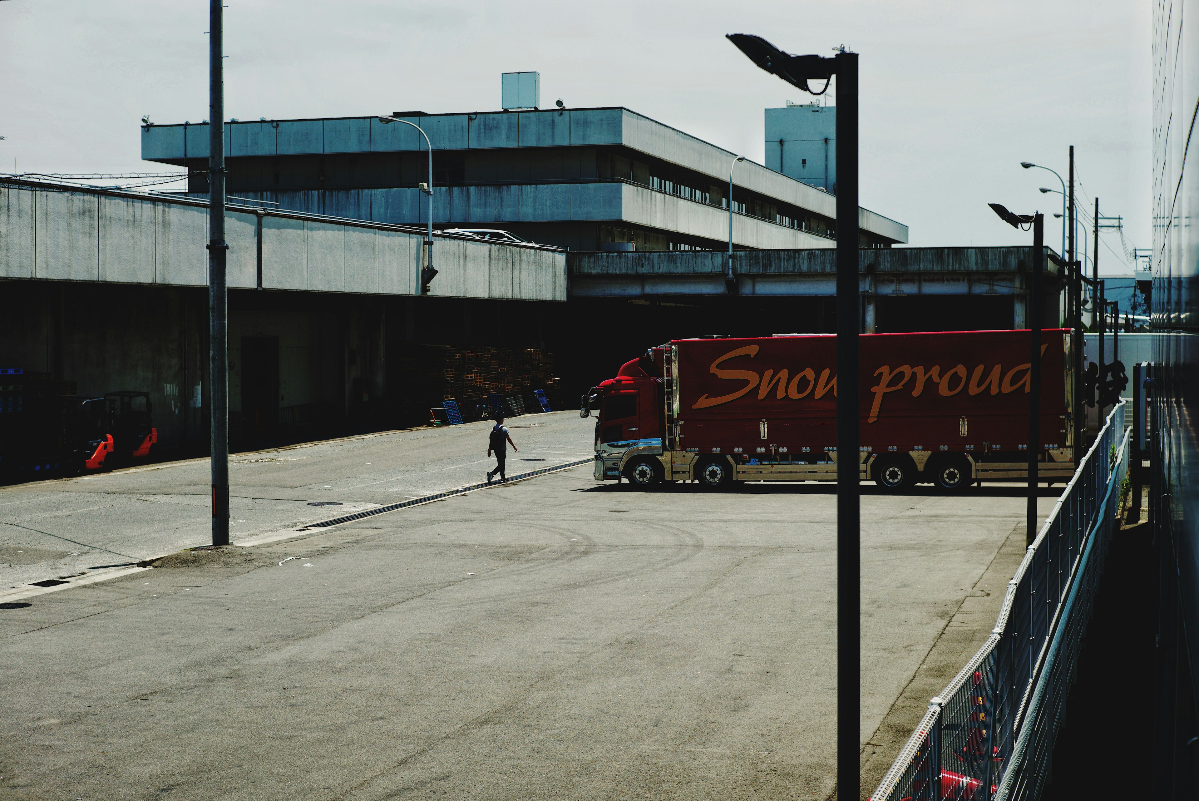 Image of a truck parked in a warehouse area with a pedestrian