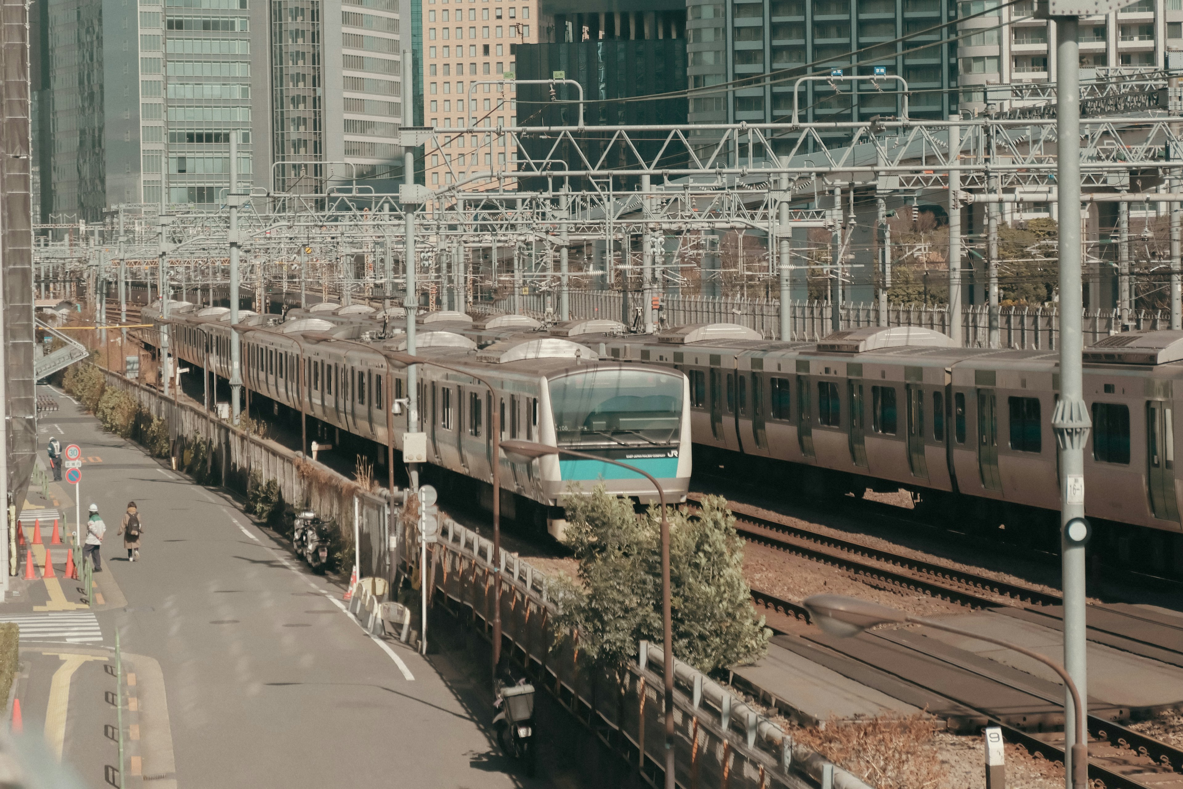 A train running on tracks surrounded by skyscrapers