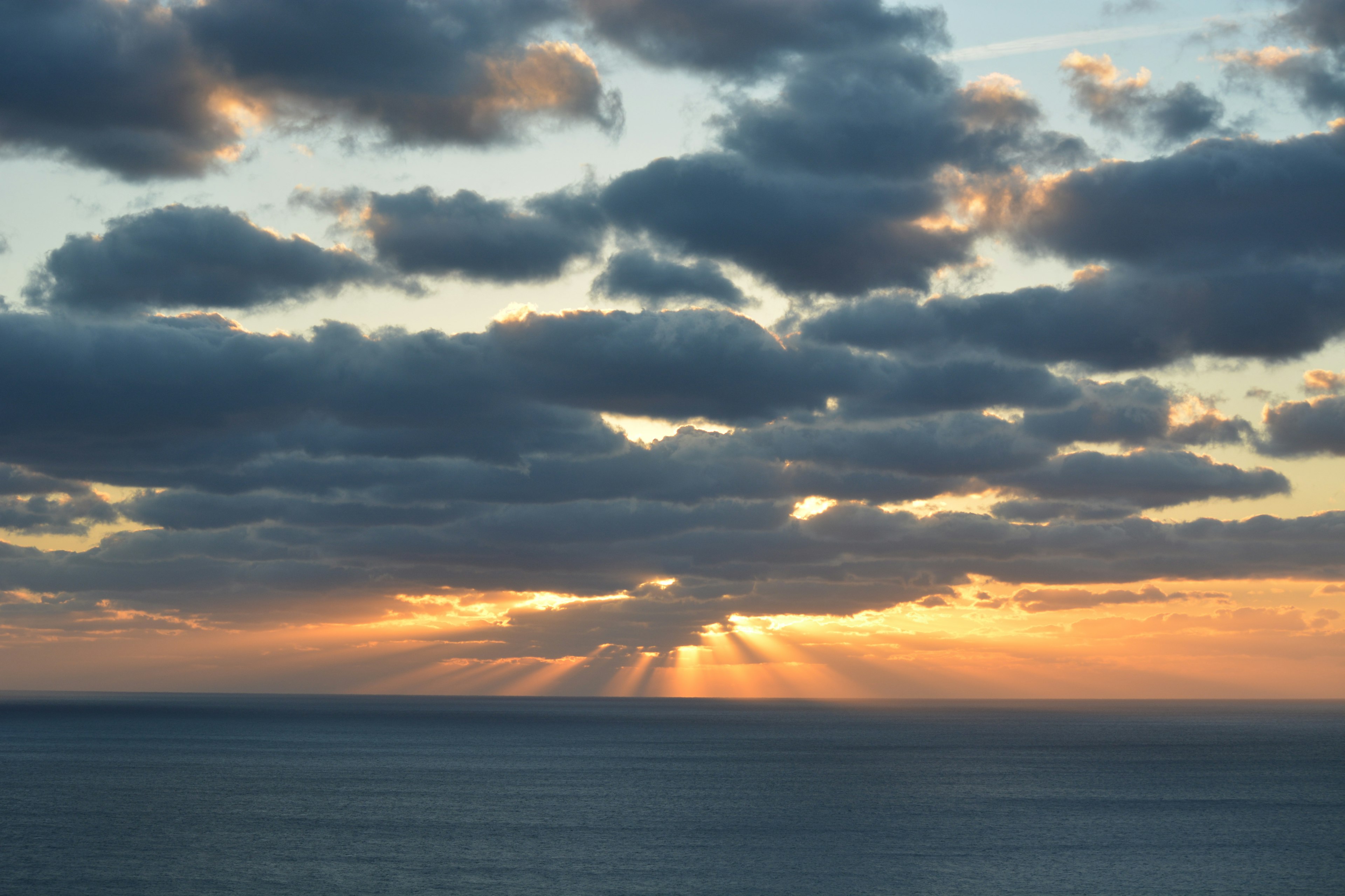 美しい夕焼けと雲の景色 海の上に広がる光の筋