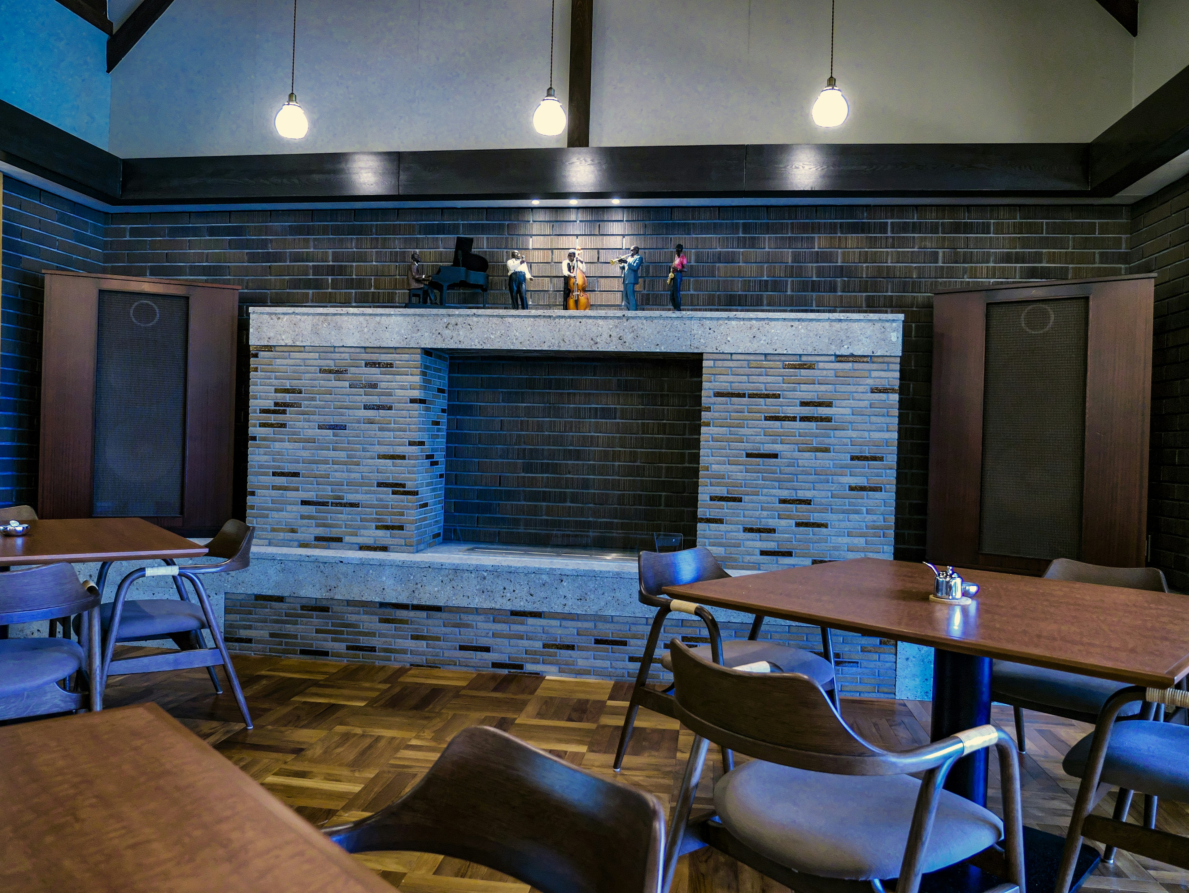 Modern café interior featuring ambient lighting and a stone fireplace