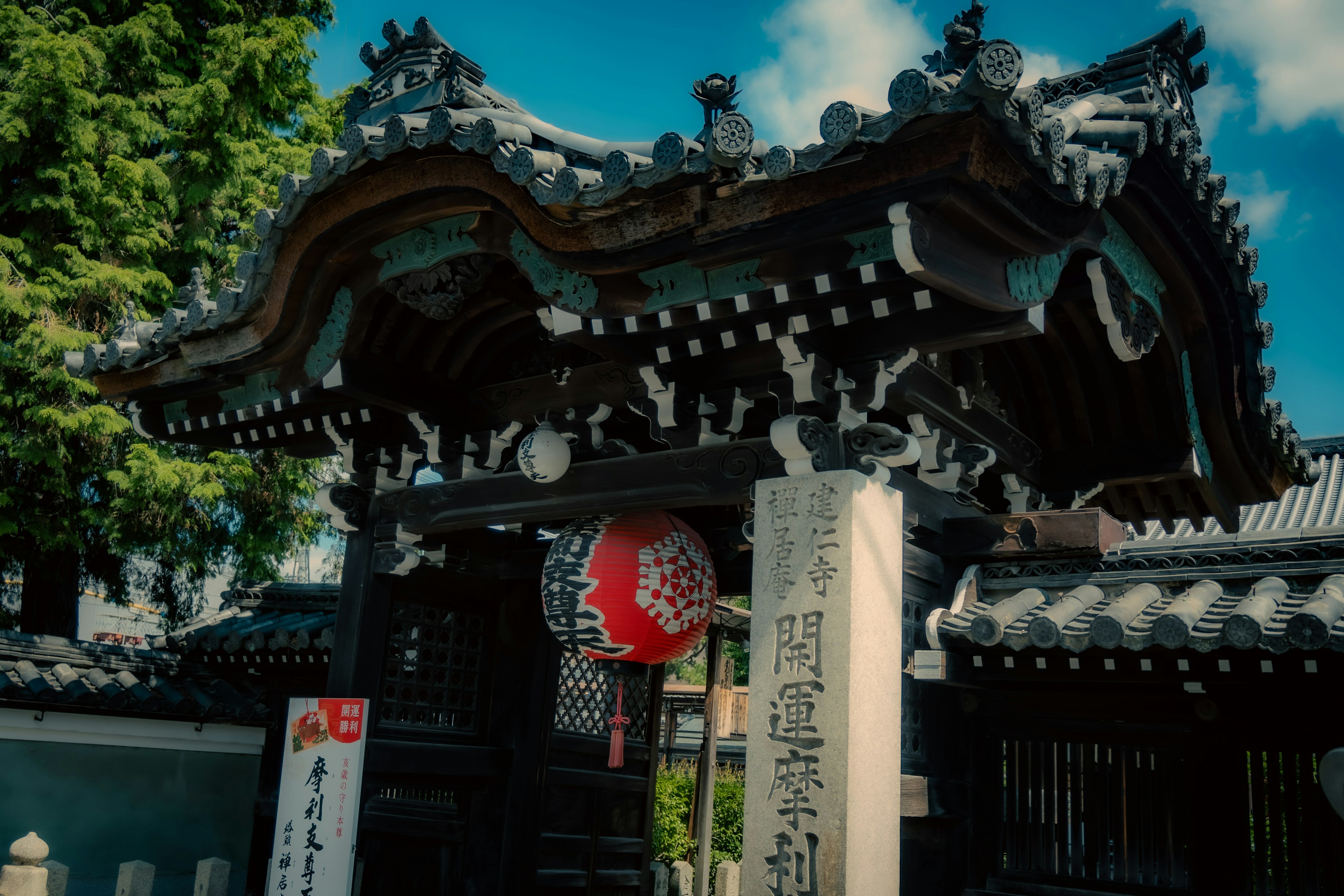 美しい日本の寺院の門、伝統的な屋根と赤い提灯が特徴