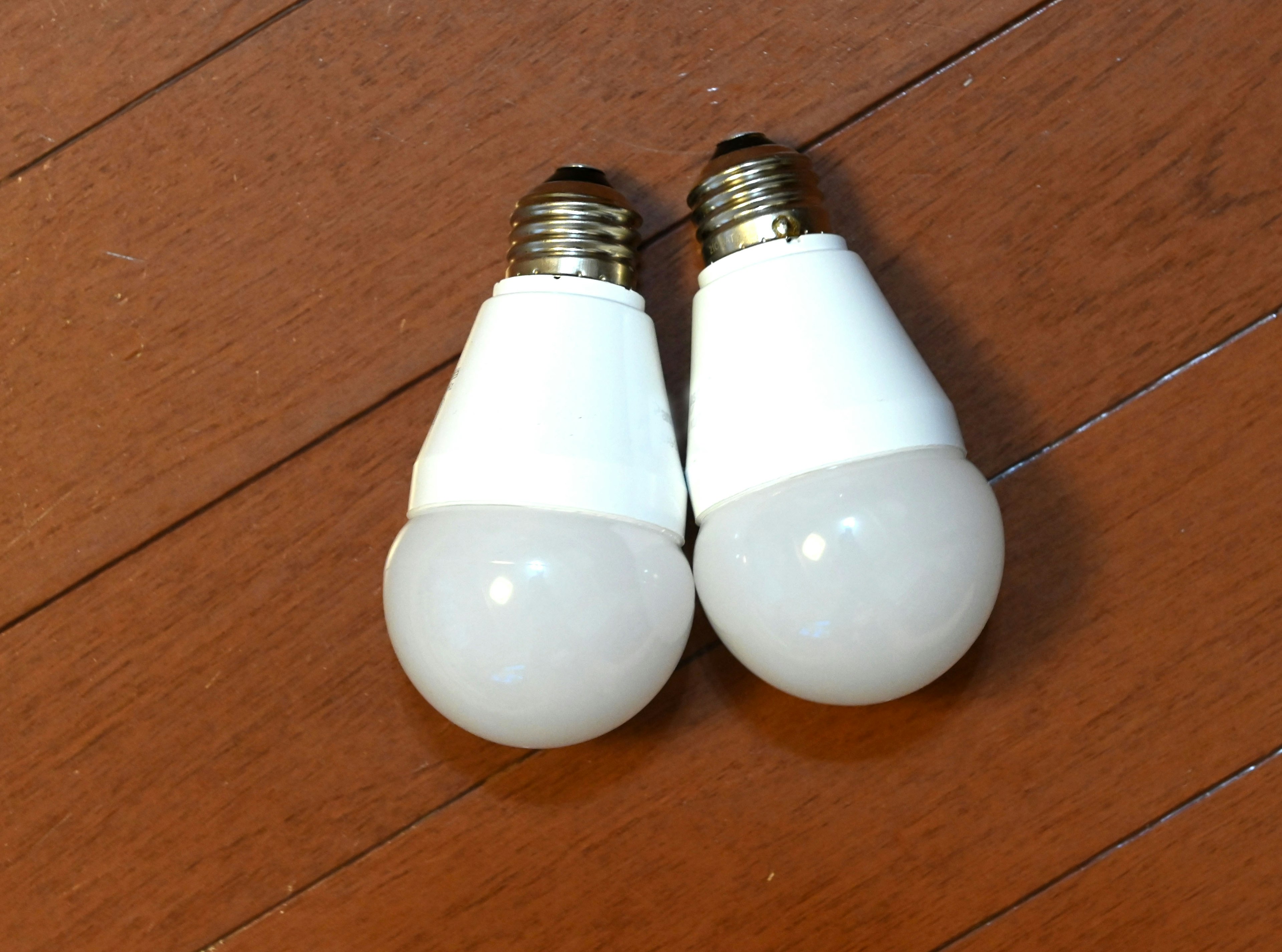 Two white LED light bulbs placed side by side