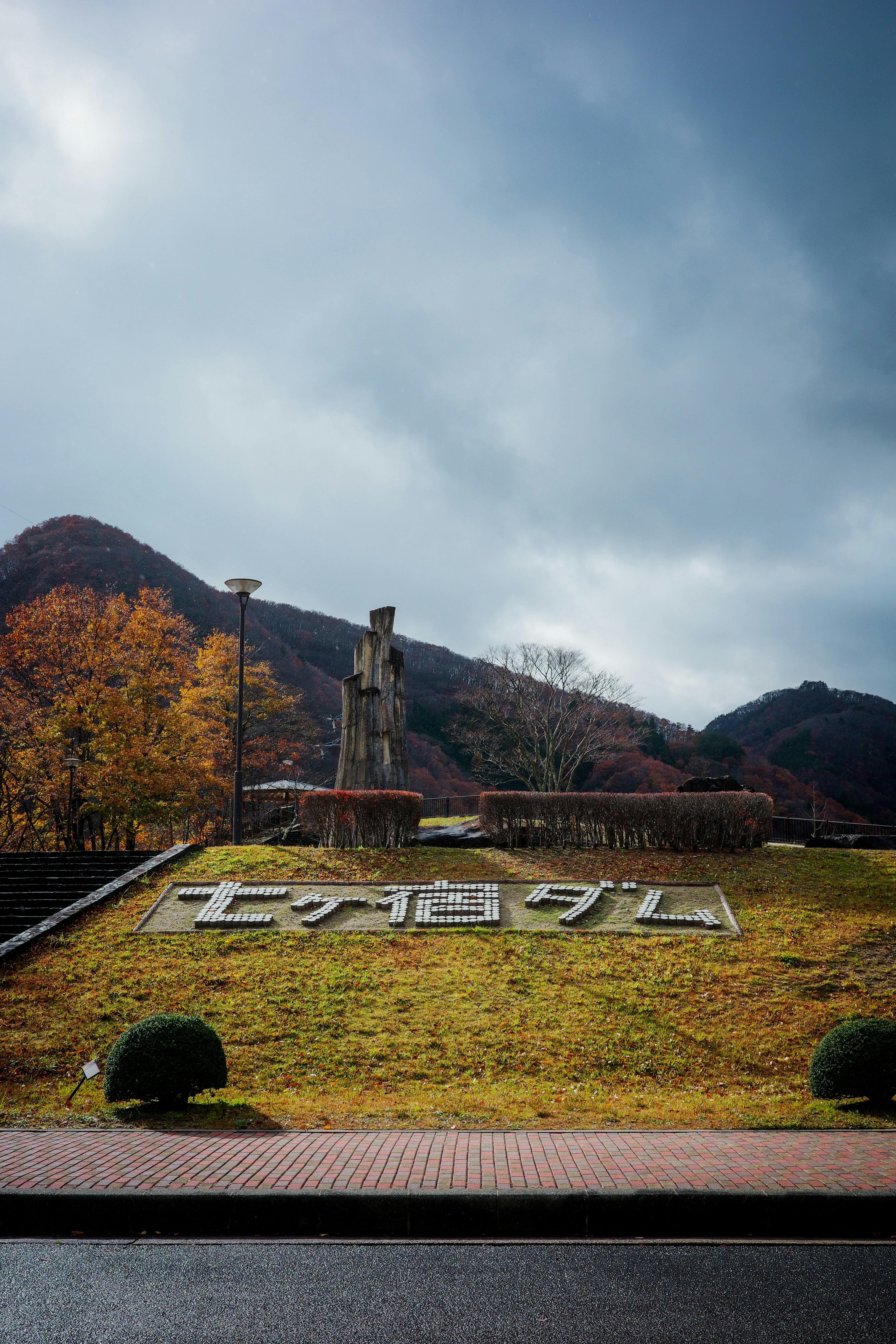 公園入口的大型標誌，四周環繞著山脈和秋季風景