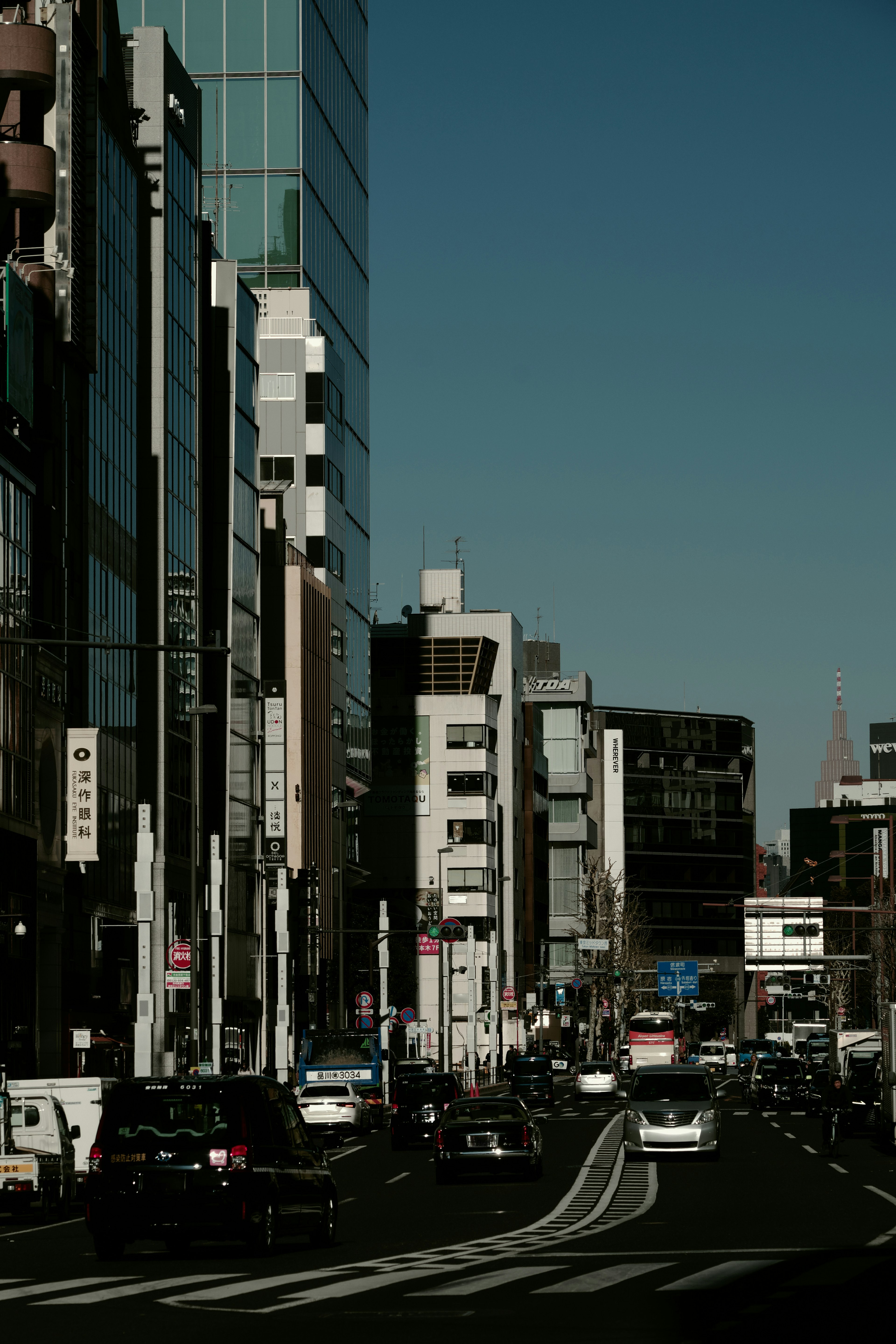 Urban street scene with tall buildings and cars