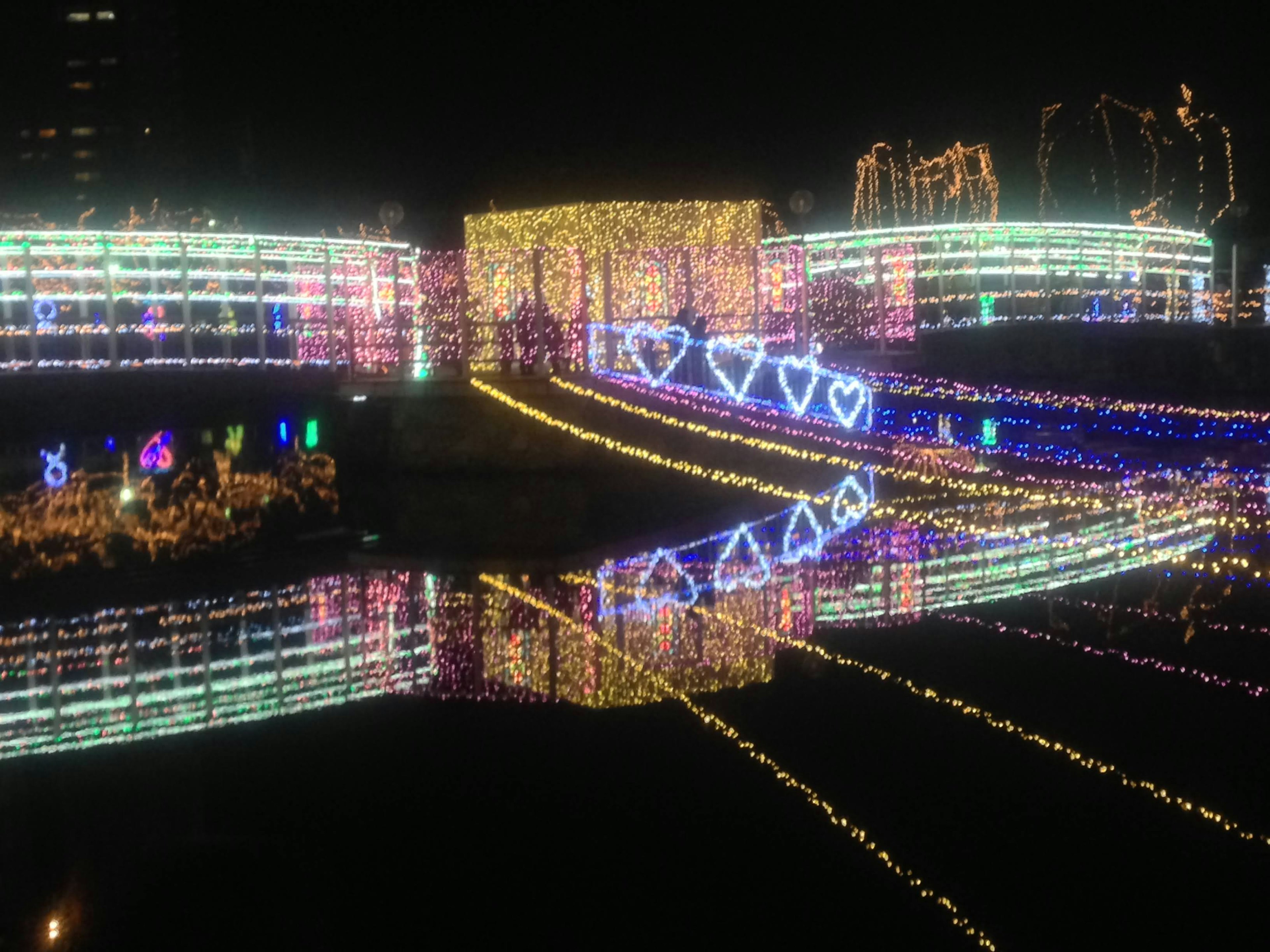 Colorful illuminated bridge reflecting on the river at night