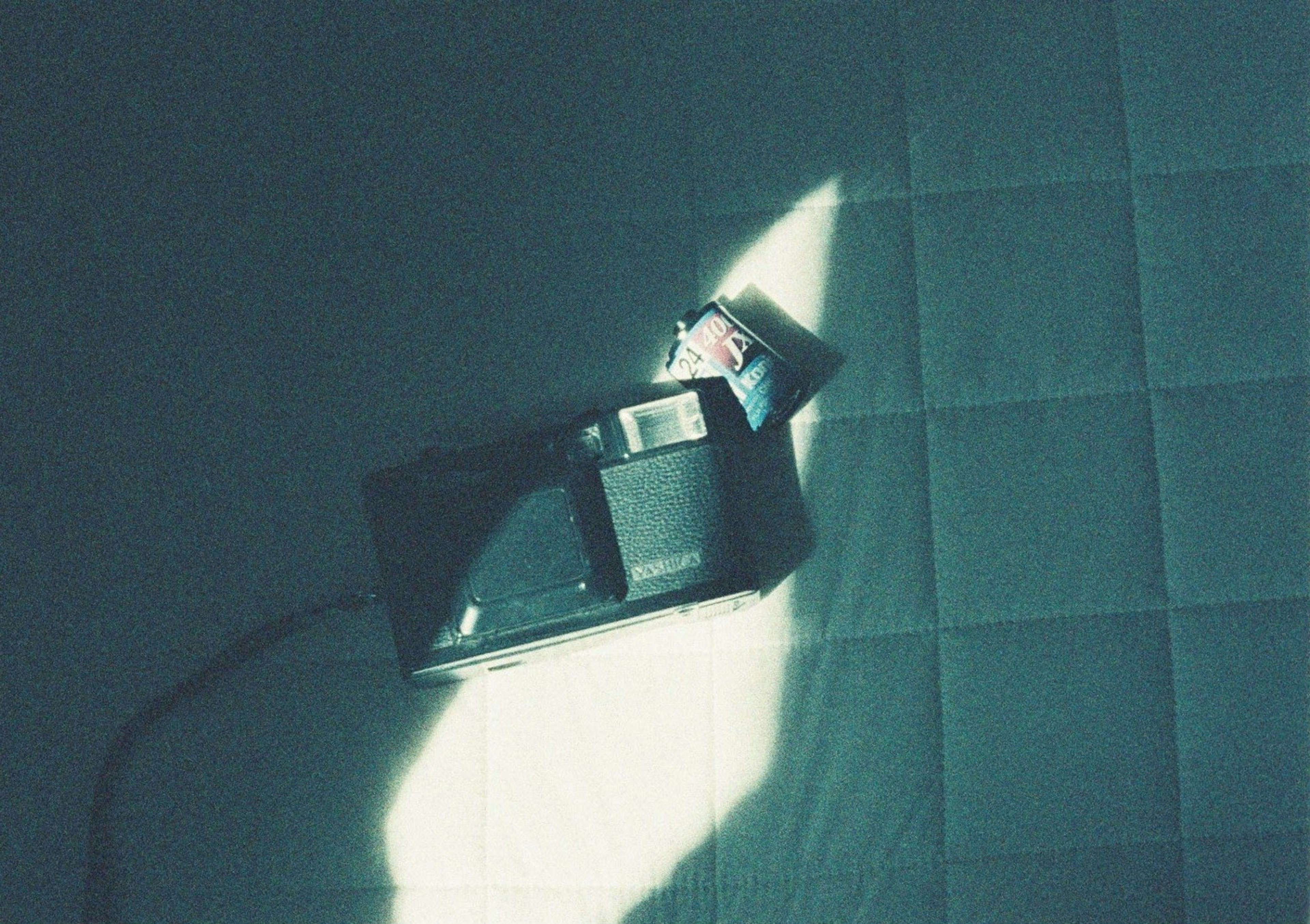 Camera and film package on a blue background