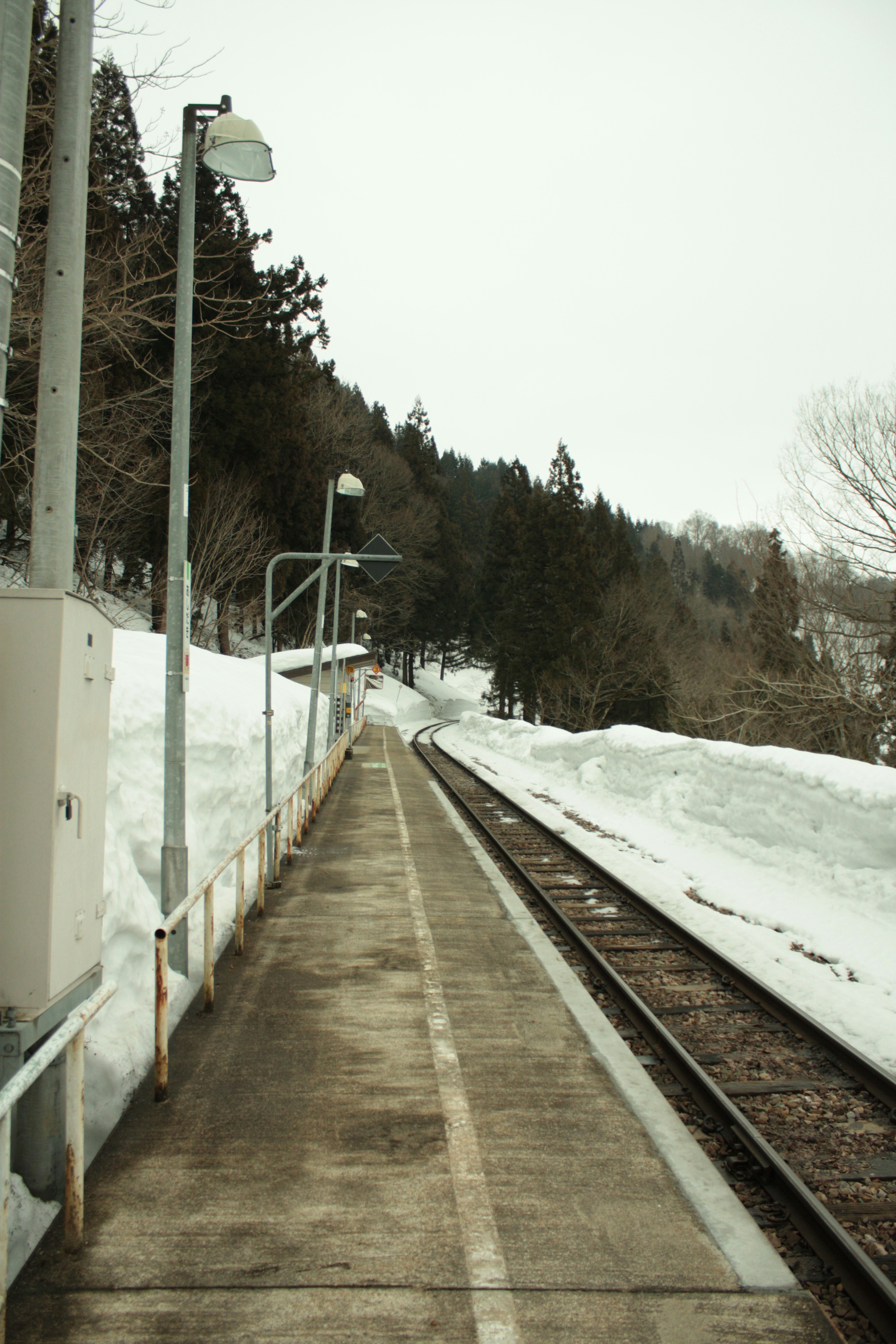 Snow-covered railway tracks and platform scene