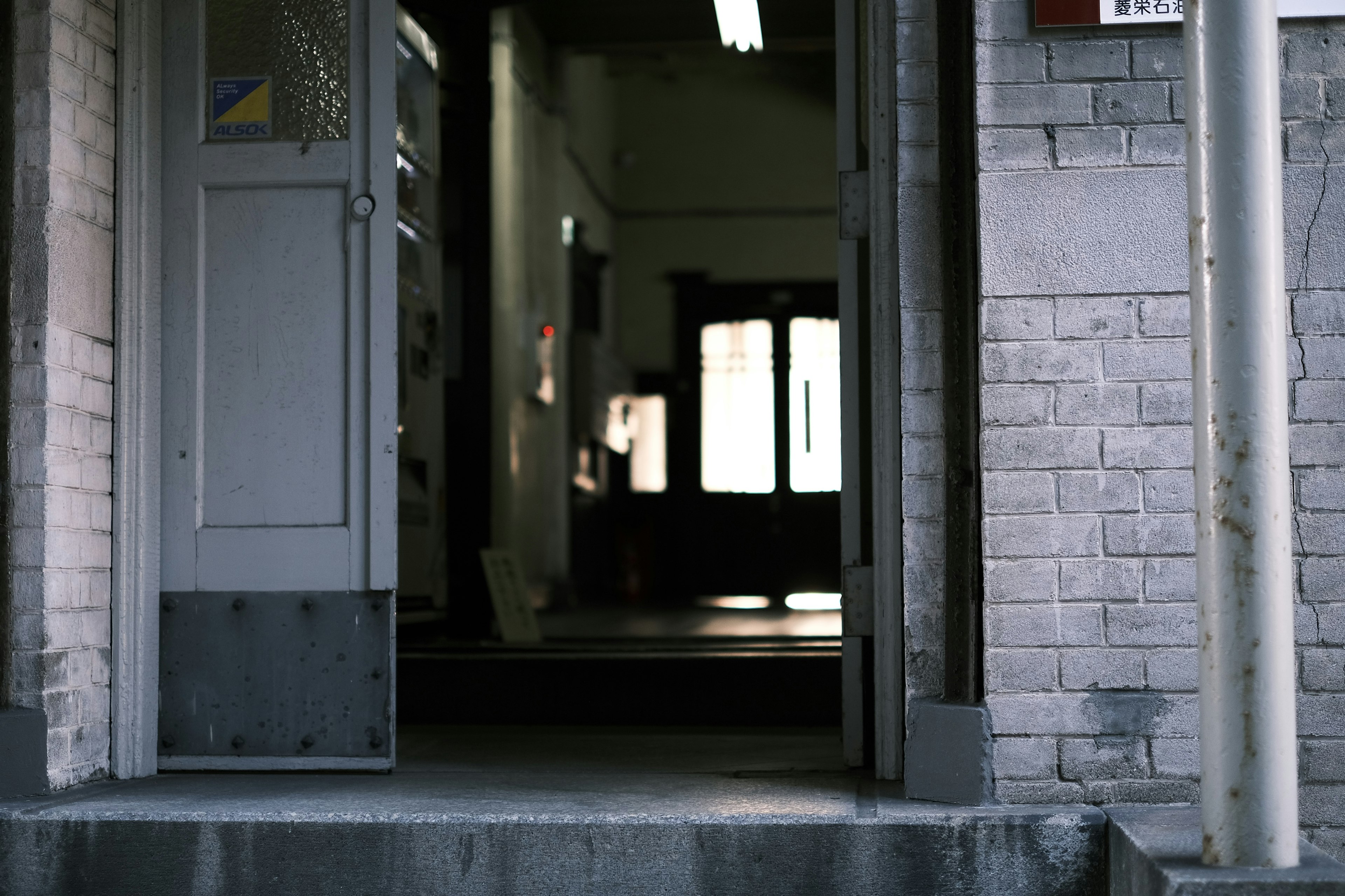 Open door leading to a dimly lit interior of a building