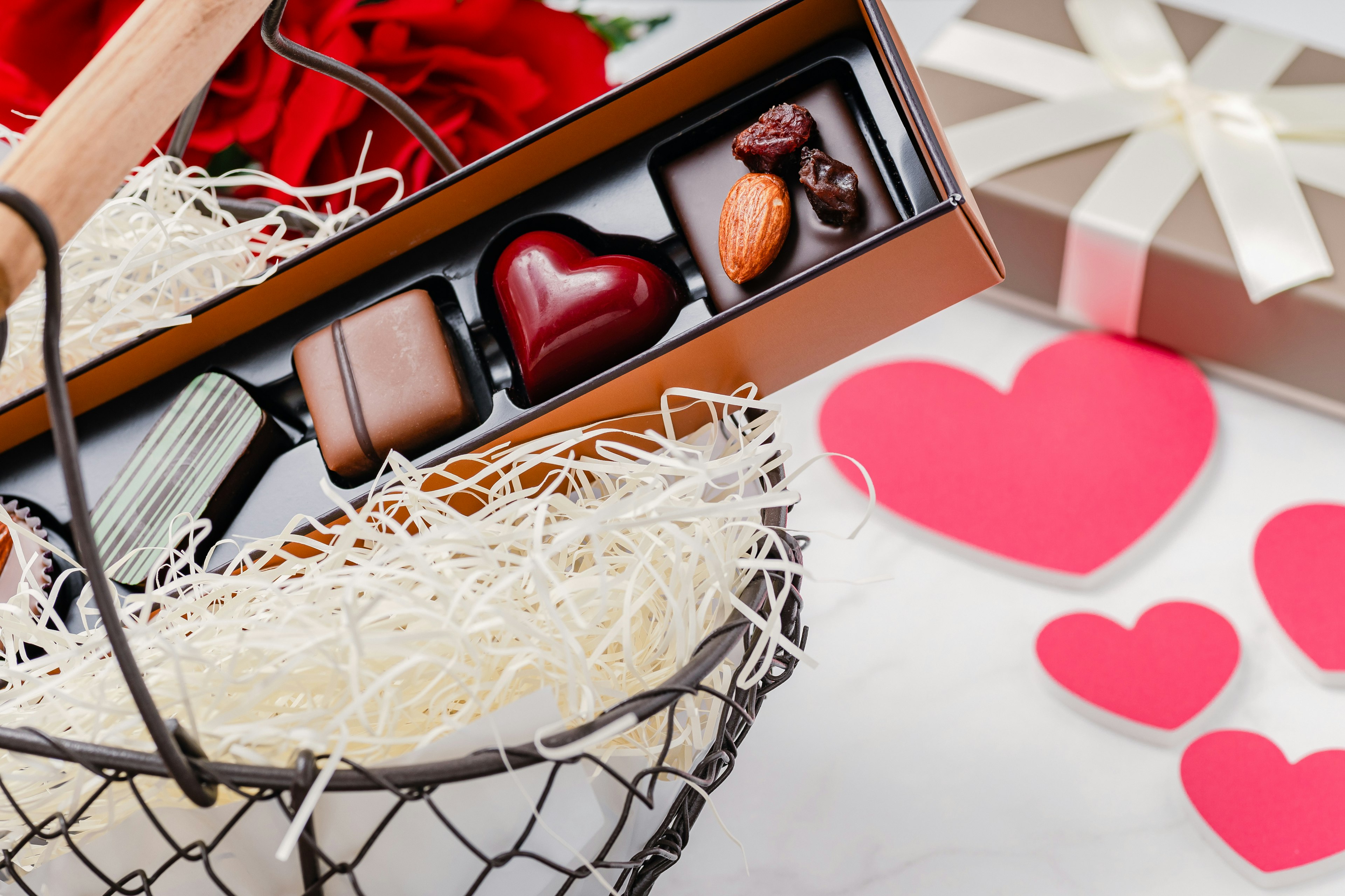 Valentine's Day gift box with heart-shaped chocolates and red roses