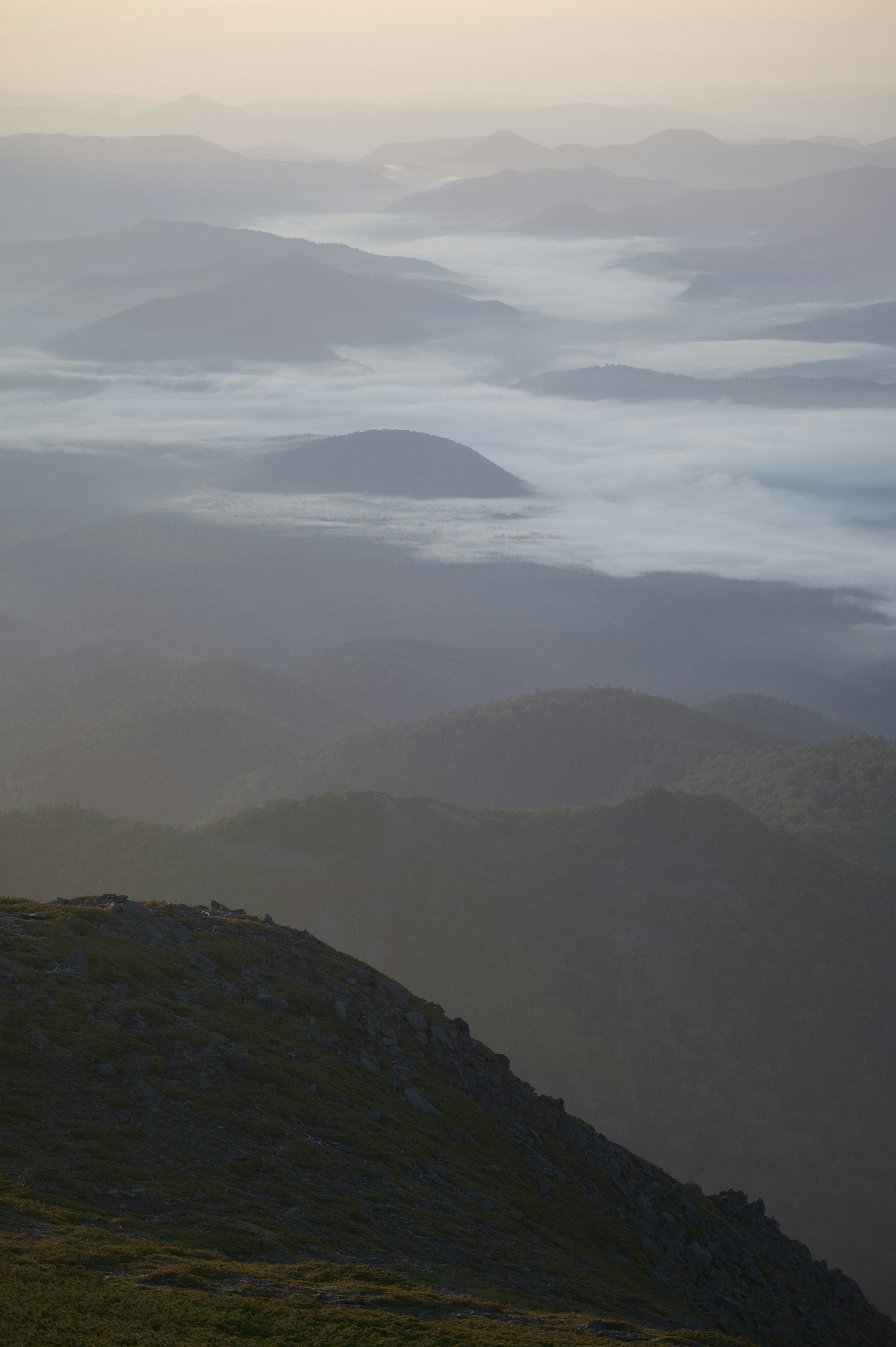 A landscape of mist-covered mountains during twilight showcasing natural beauty