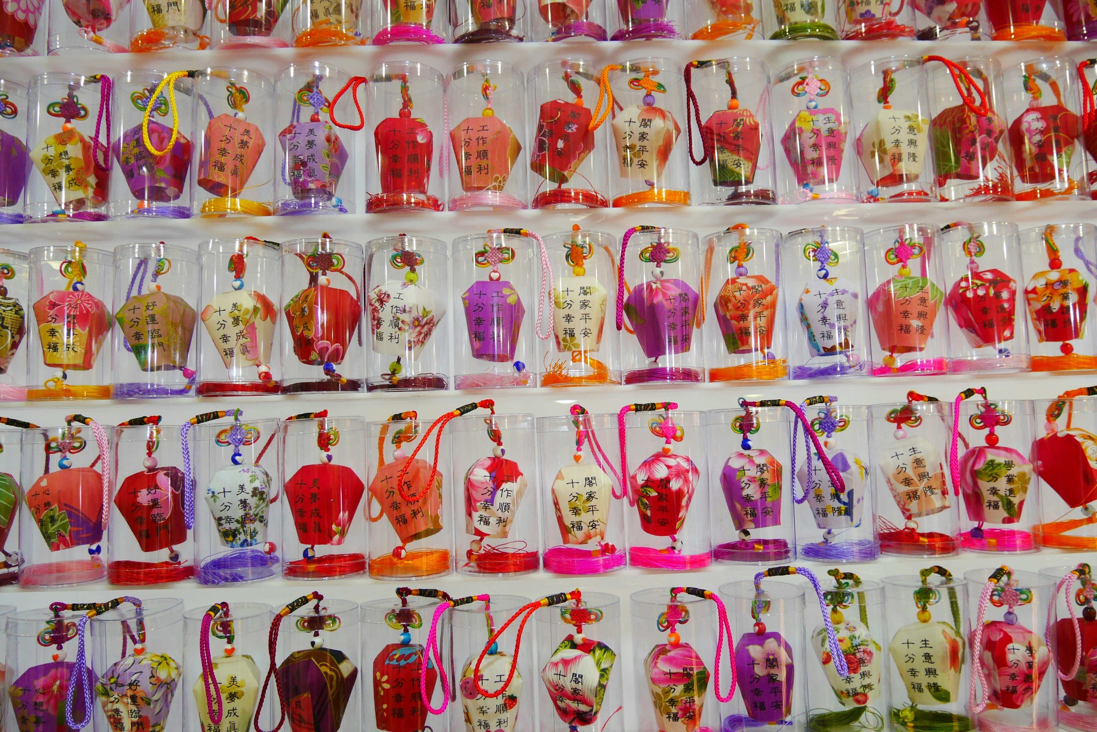 Colorful small amulets displayed in rows