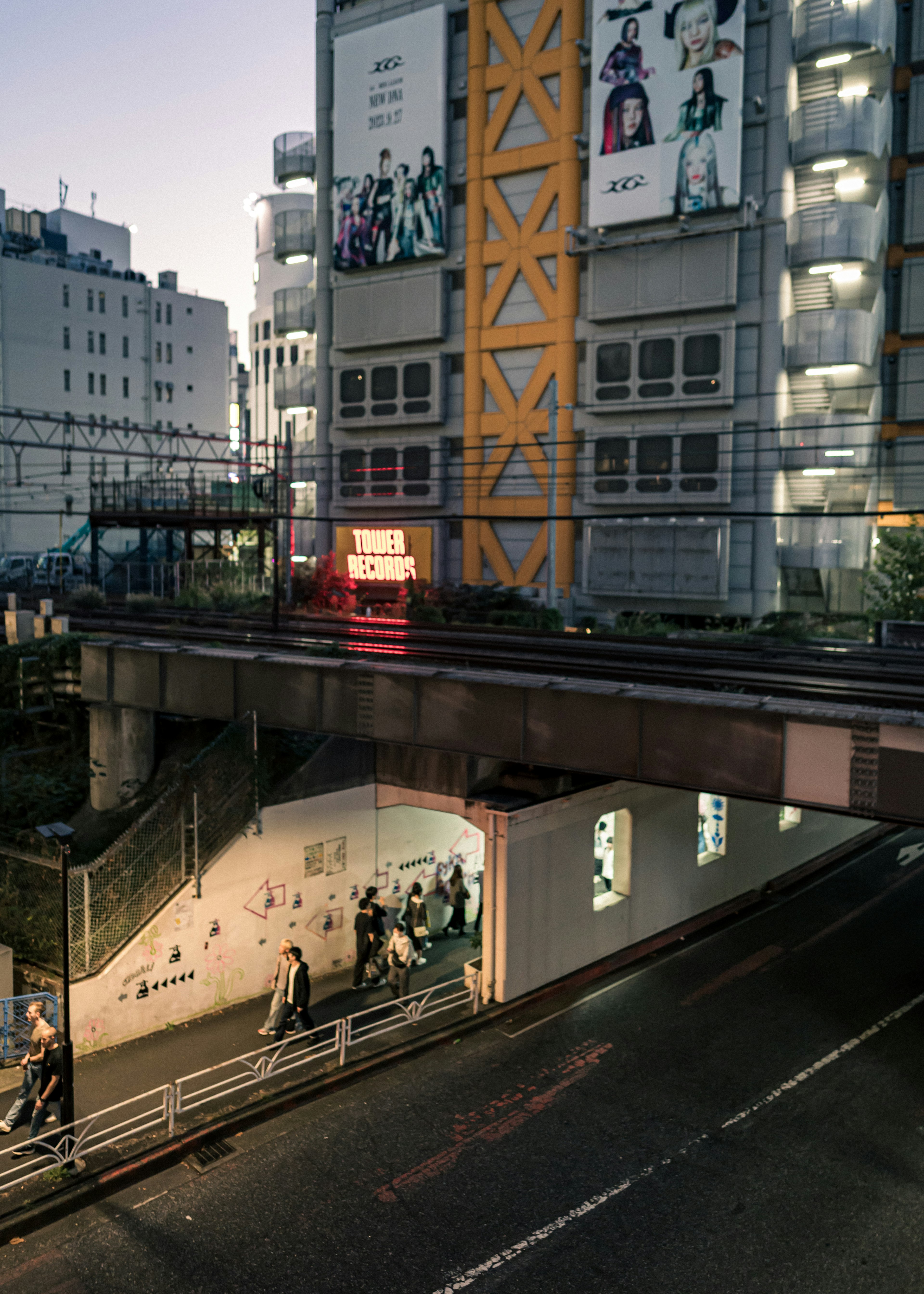 夕暮れ時の都市風景 鉄道橋の下にある地下道とビルの外観