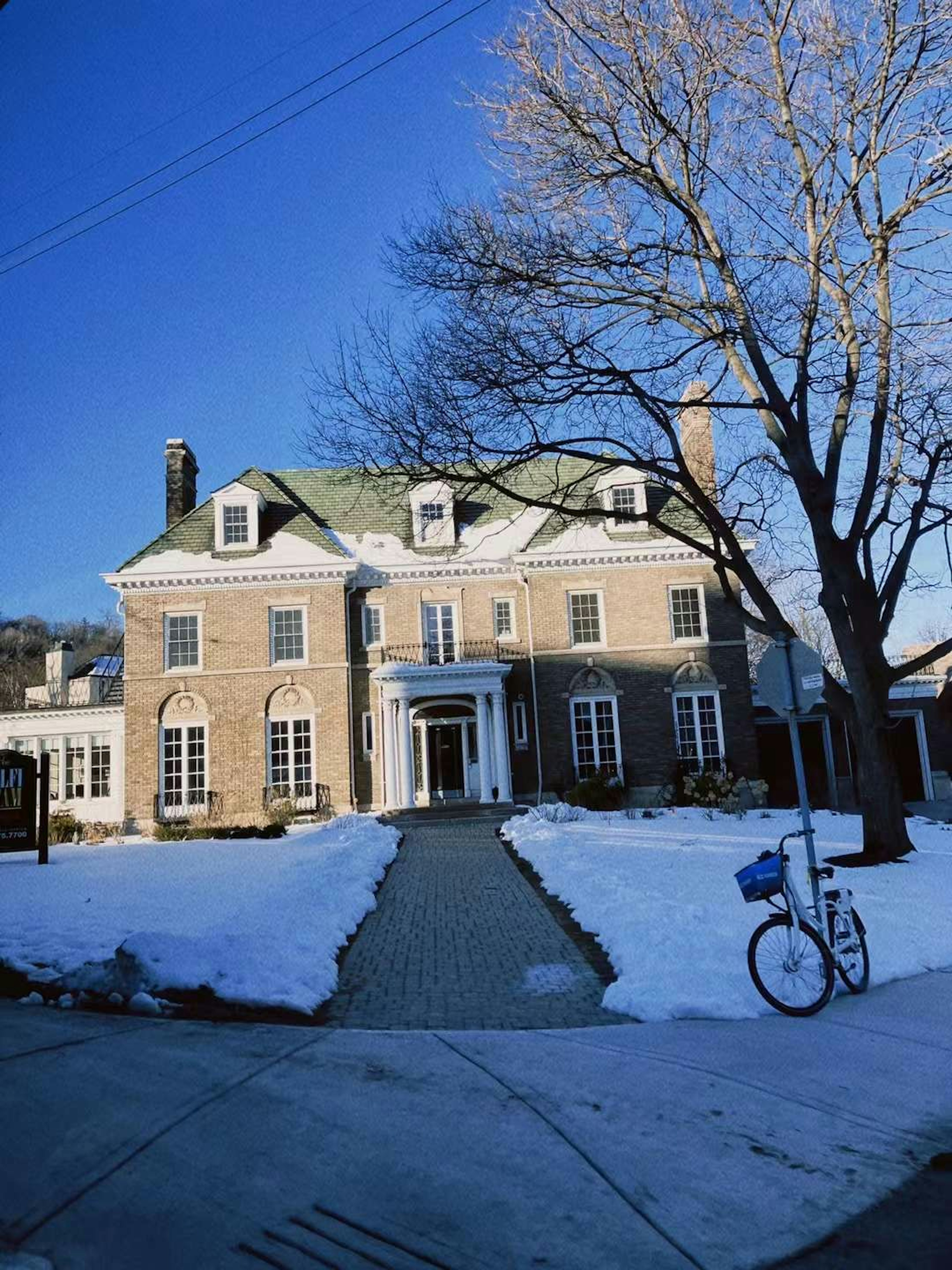 Beautiful house covered in winter snow with a clear blue sky