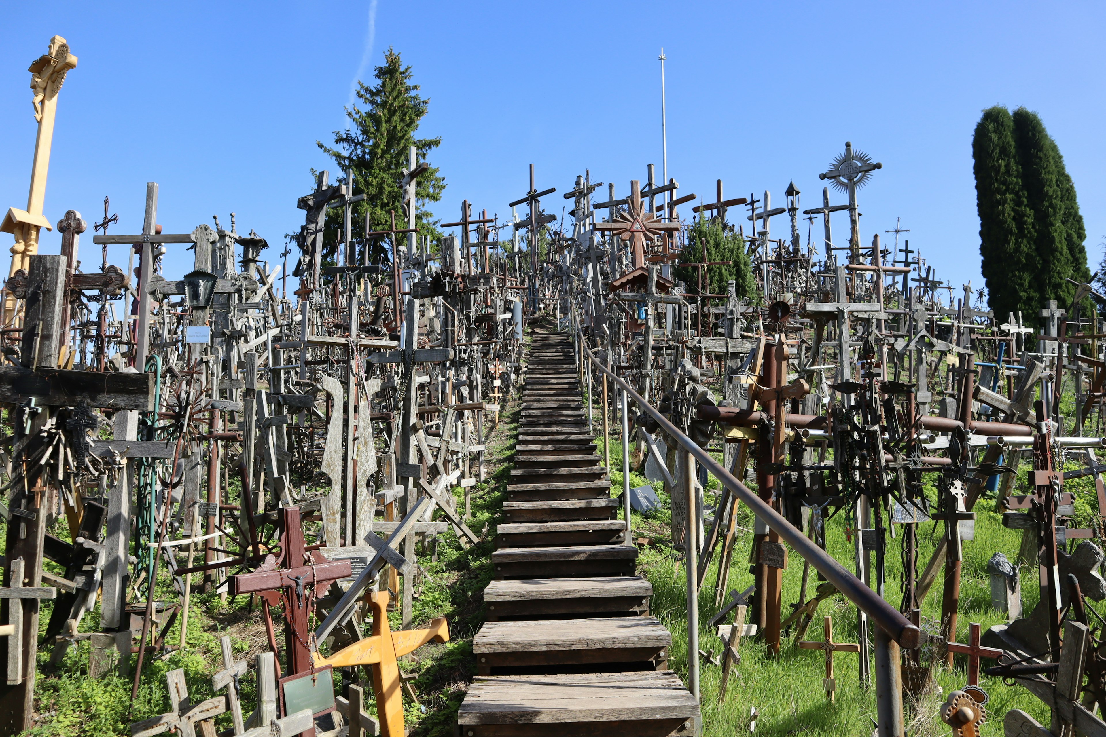 Wooden stairs leading up to a hill covered with crosses