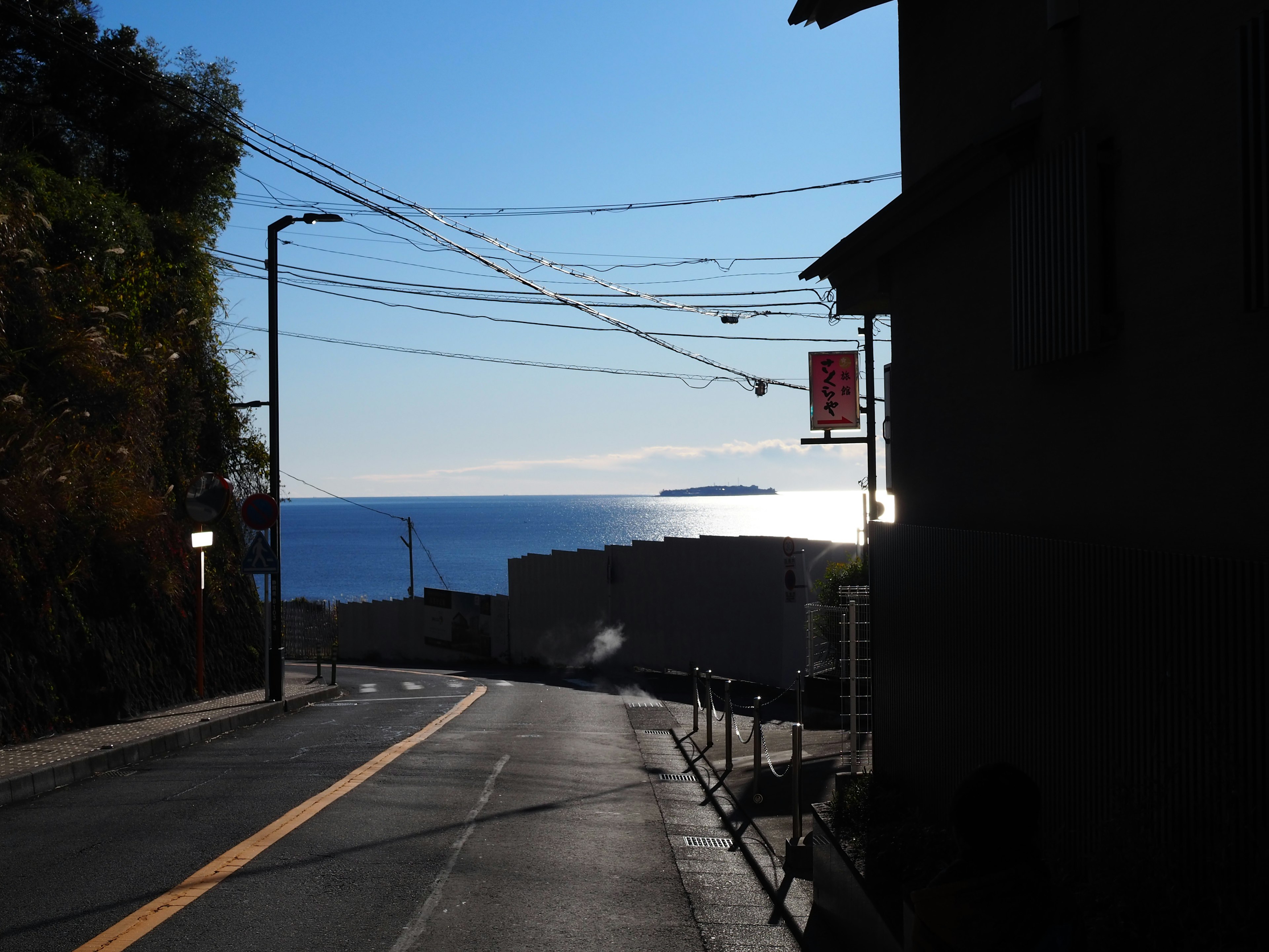 Quiet road with ocean view and blue sky