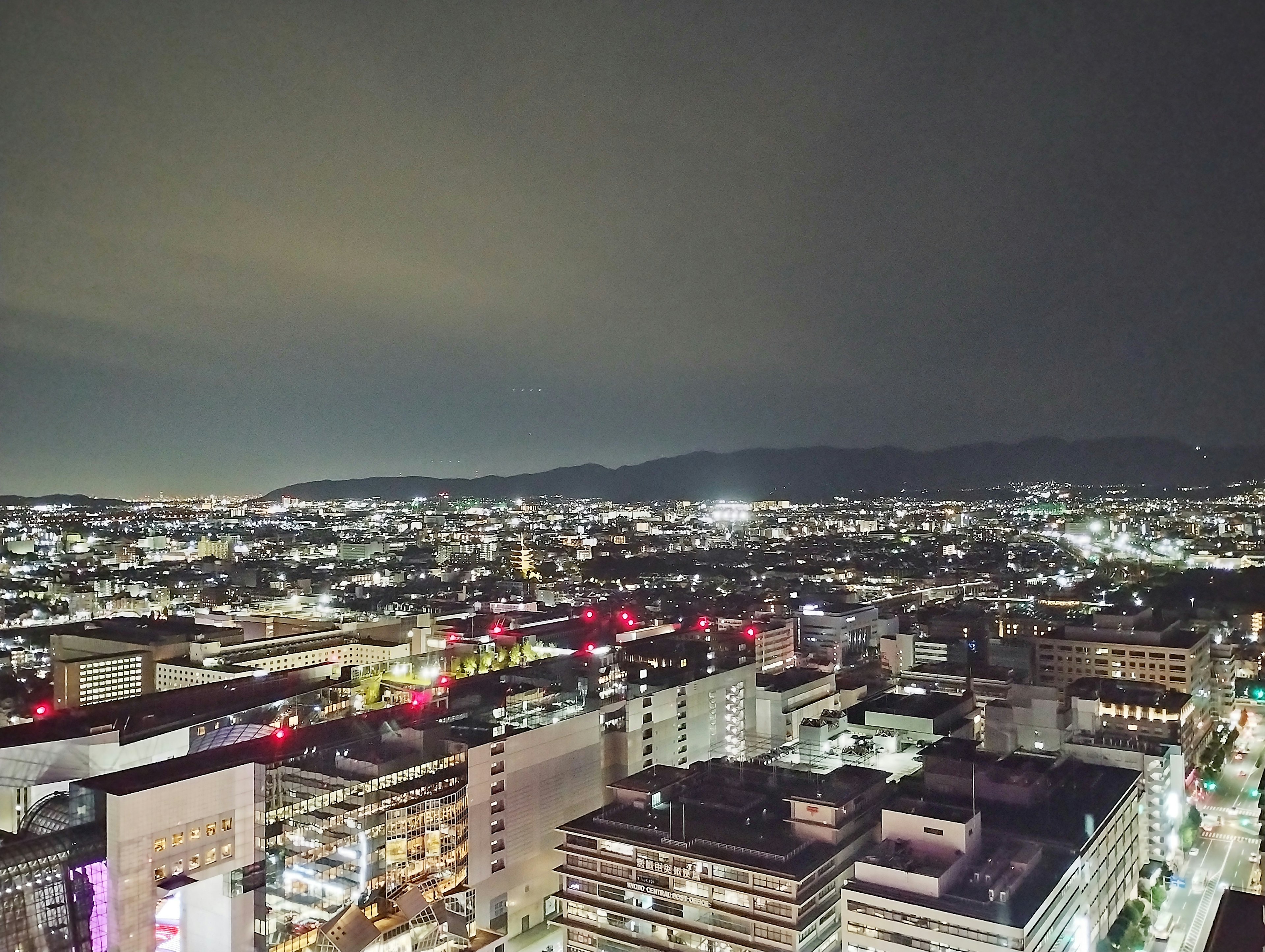 Night cityscape with bright buildings and a sea of lights