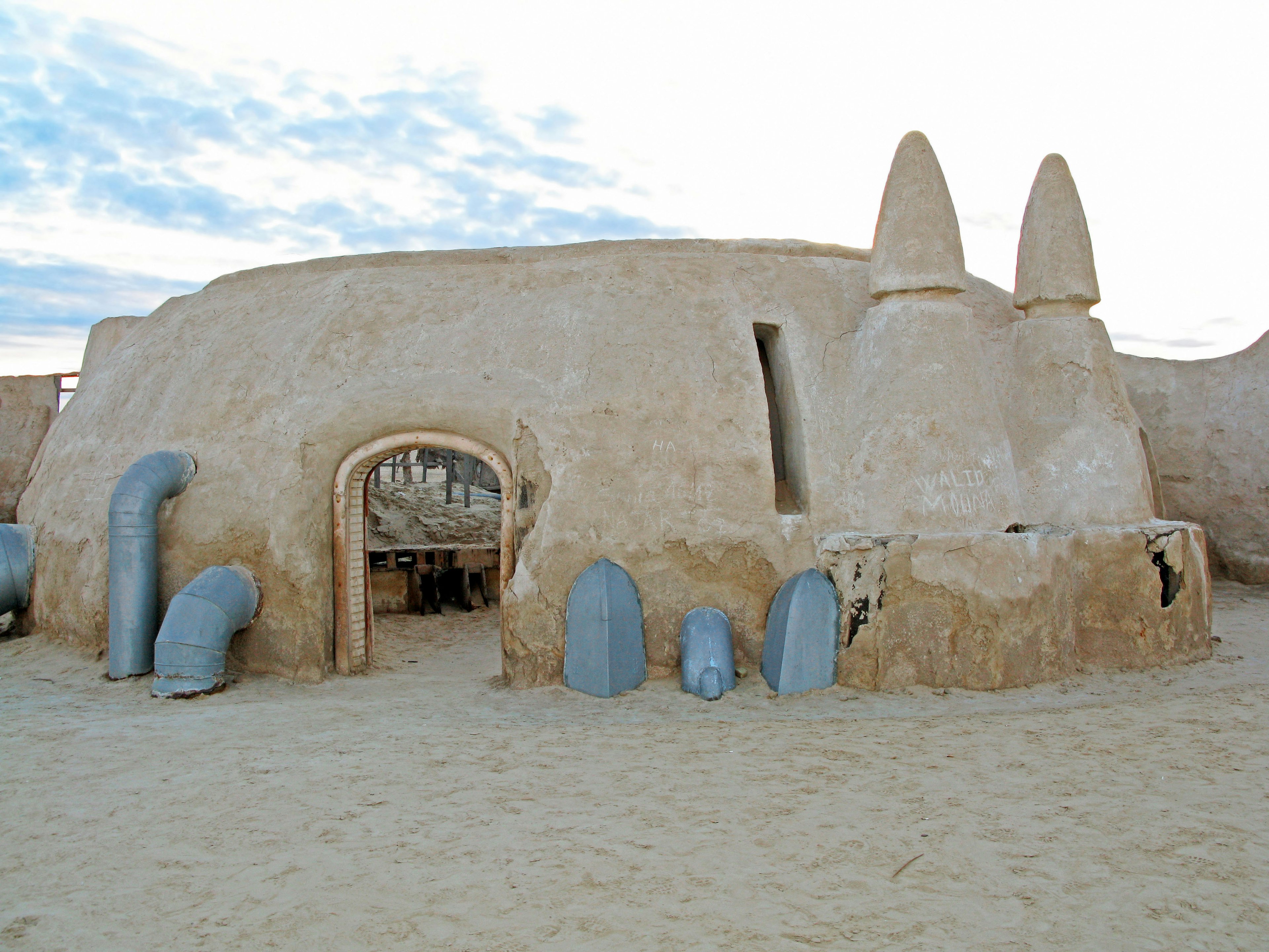 Unique structure in the desert with prominent blue pipes