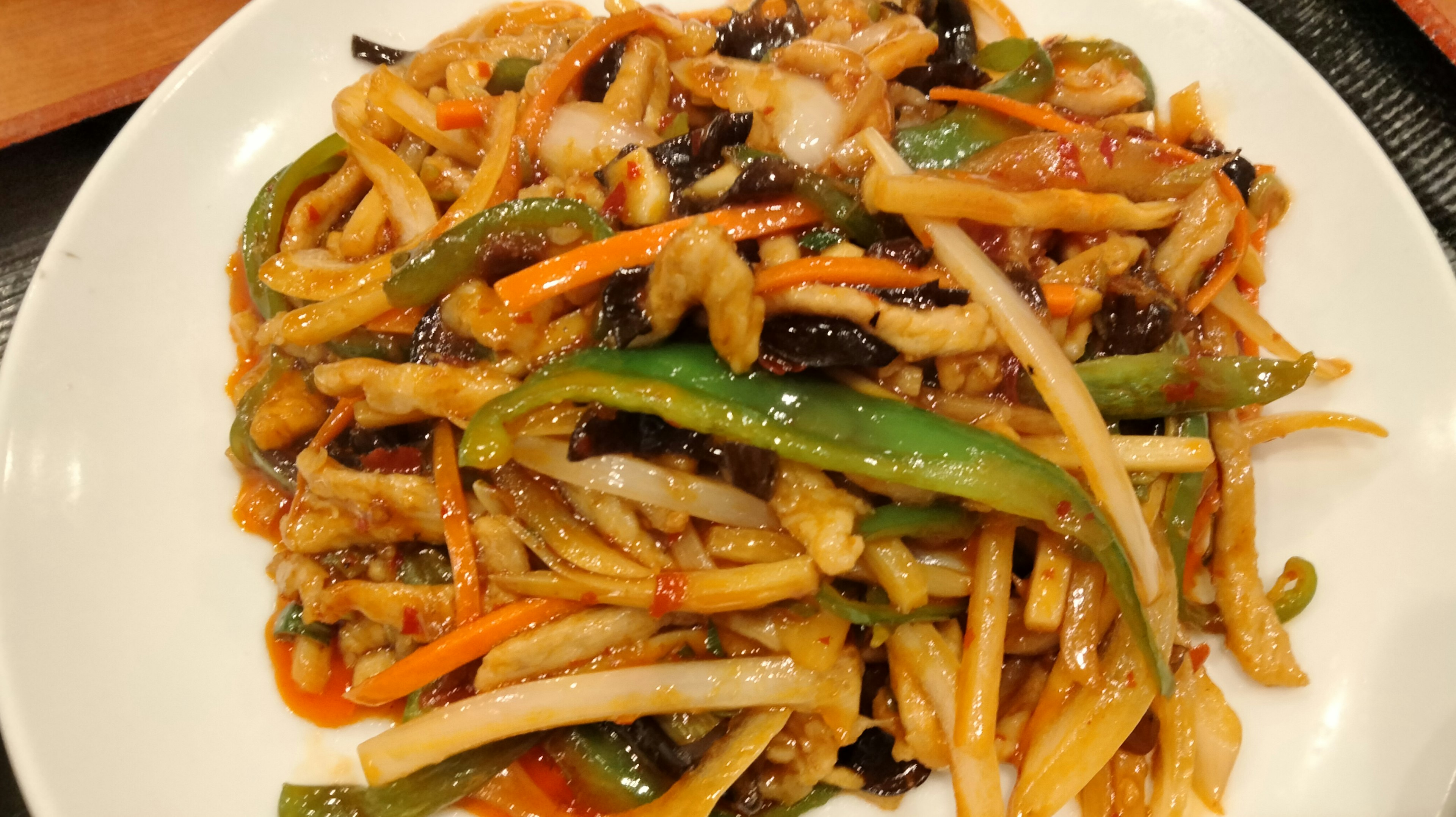 Colorful vegetable dish with long noodles