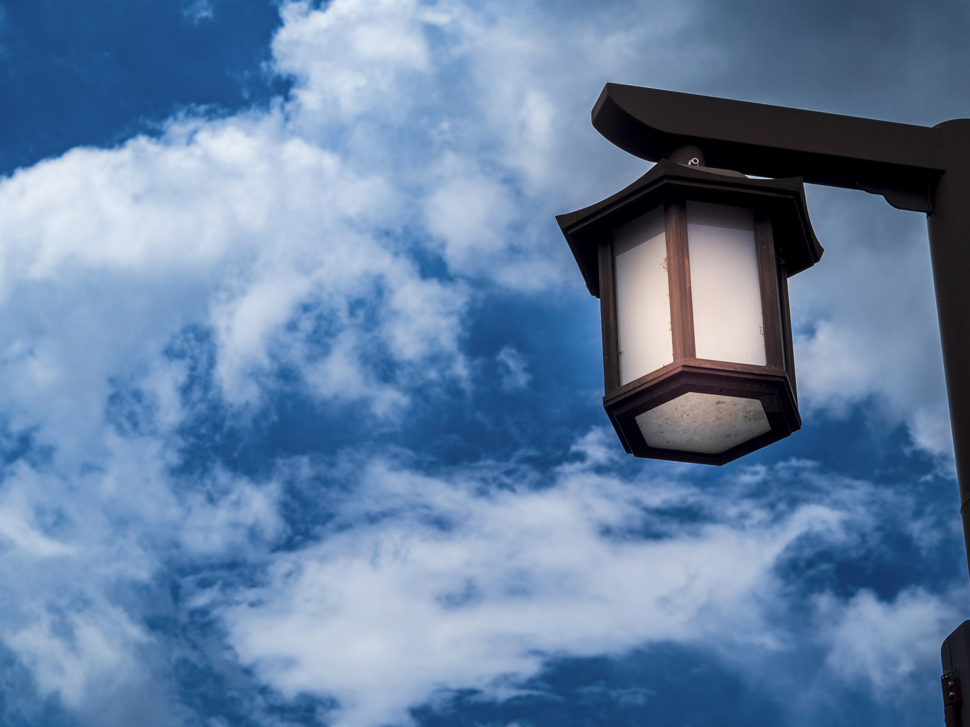 Close-up of a Japanese-style lantern under a blue sky