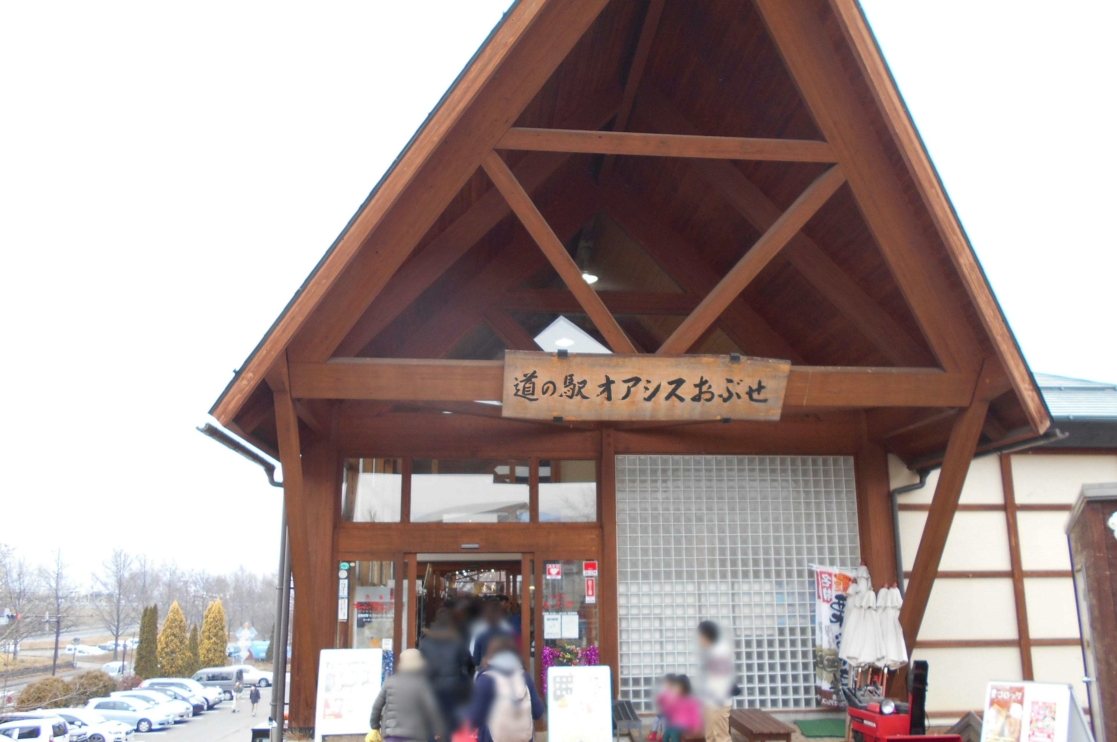 Entrance of a traditional wooden building with a sign