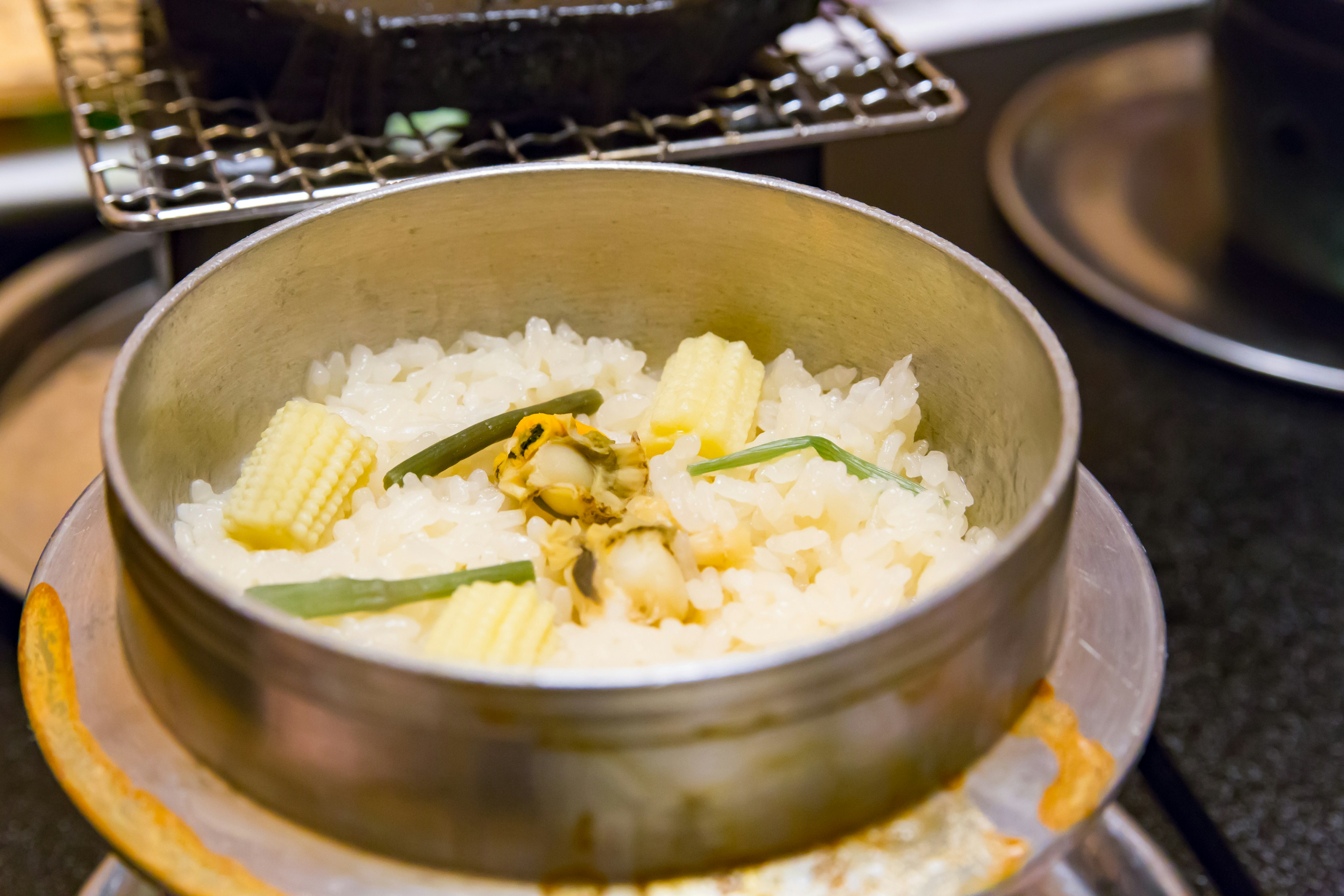 Steamed rice with ingredients in a metal bowl