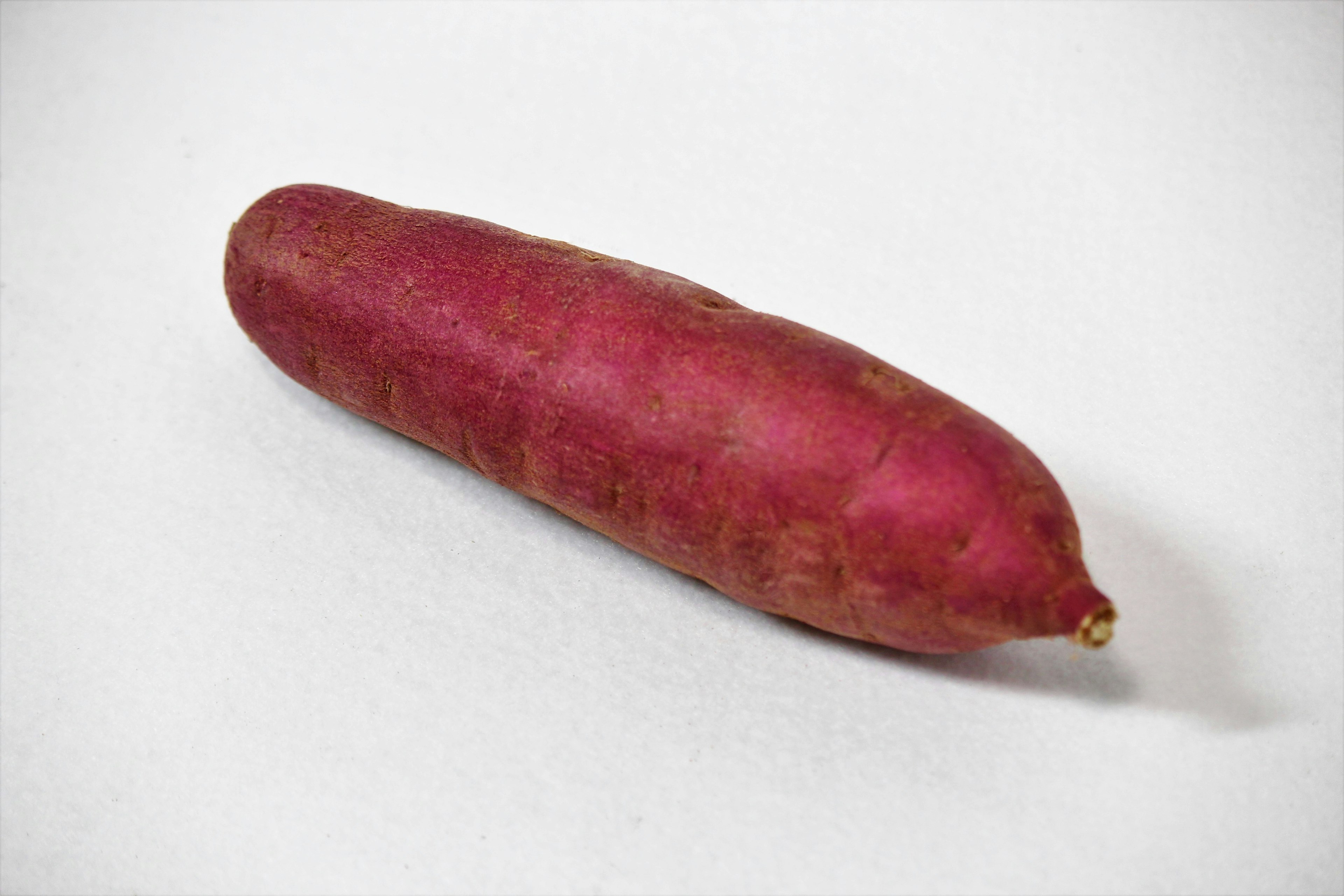 A sweet potato with a distinctive shape and vibrant color