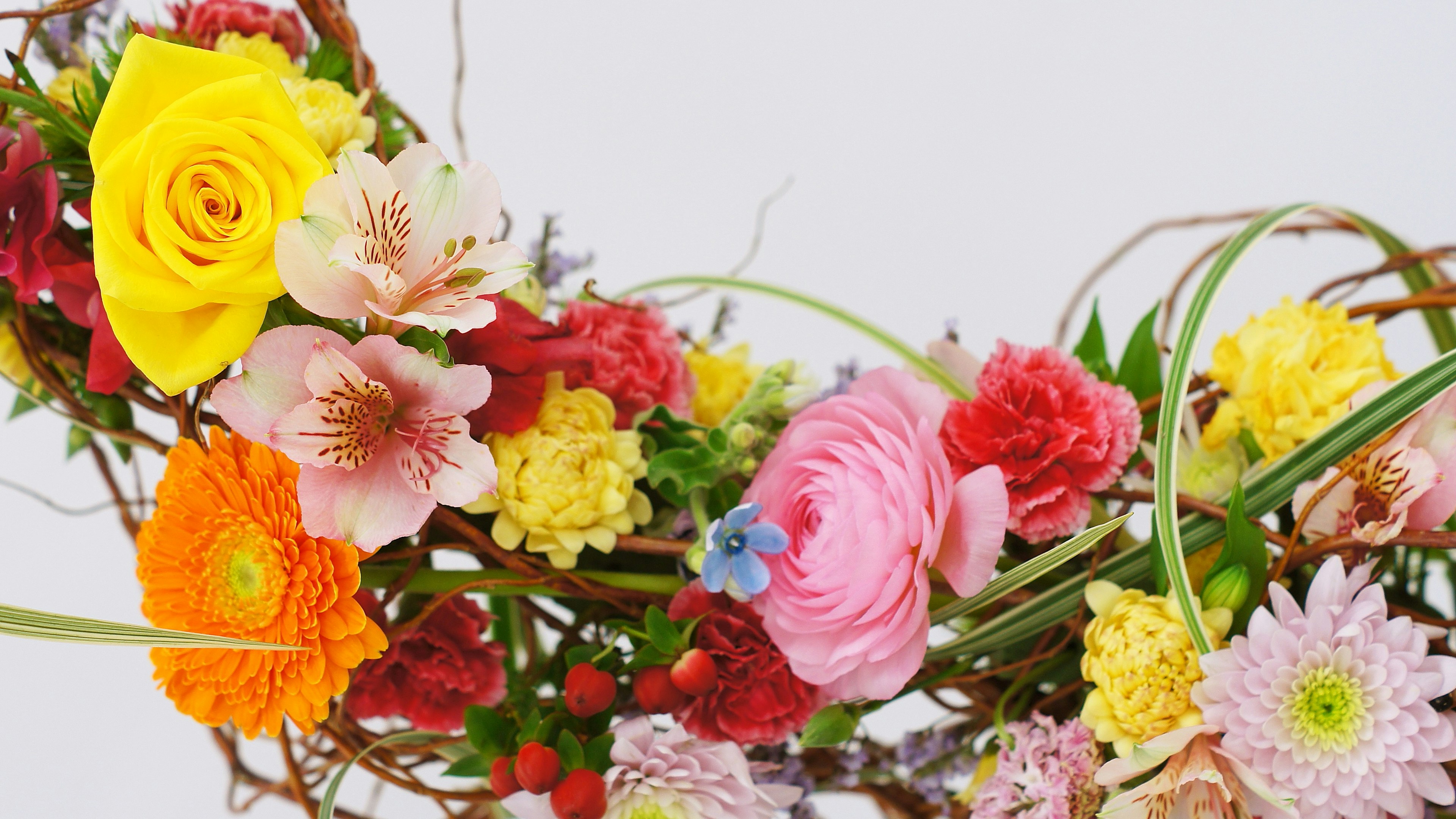 Colorful arrangement of various flowers in a vibrant floral wreath