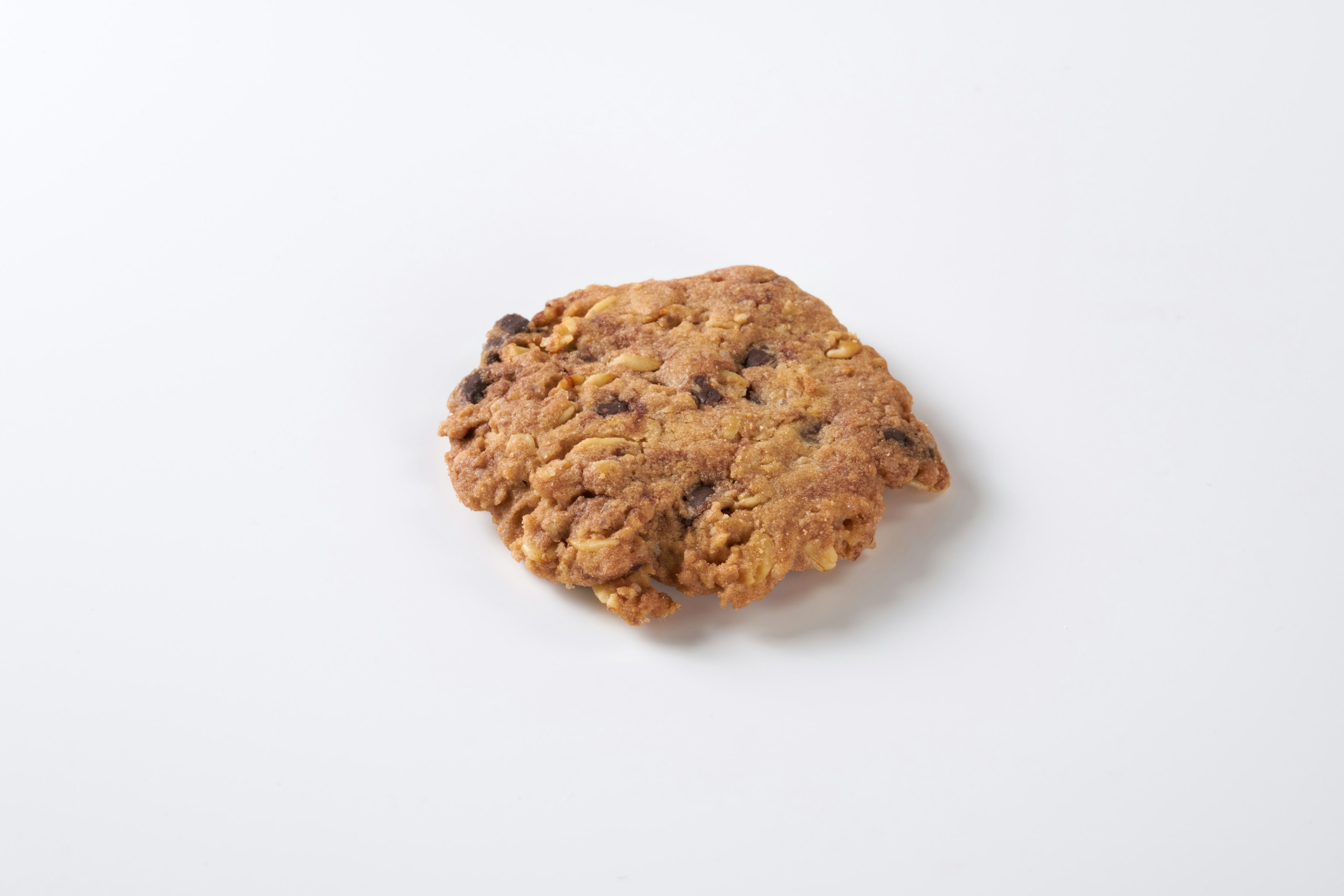 A close-up of a chocolate chip cookie on a white background