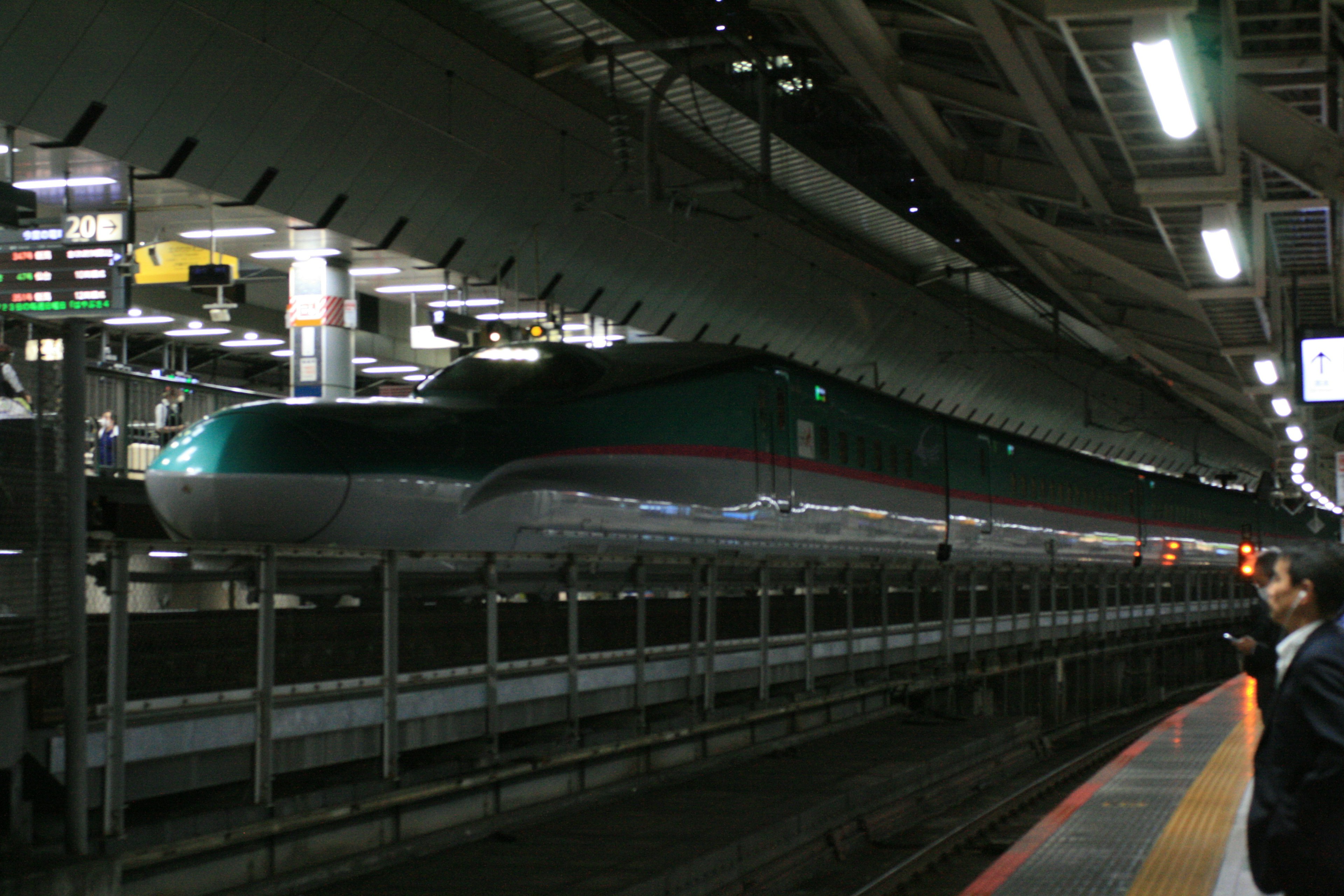 Shinkansen train at a station with platform lights