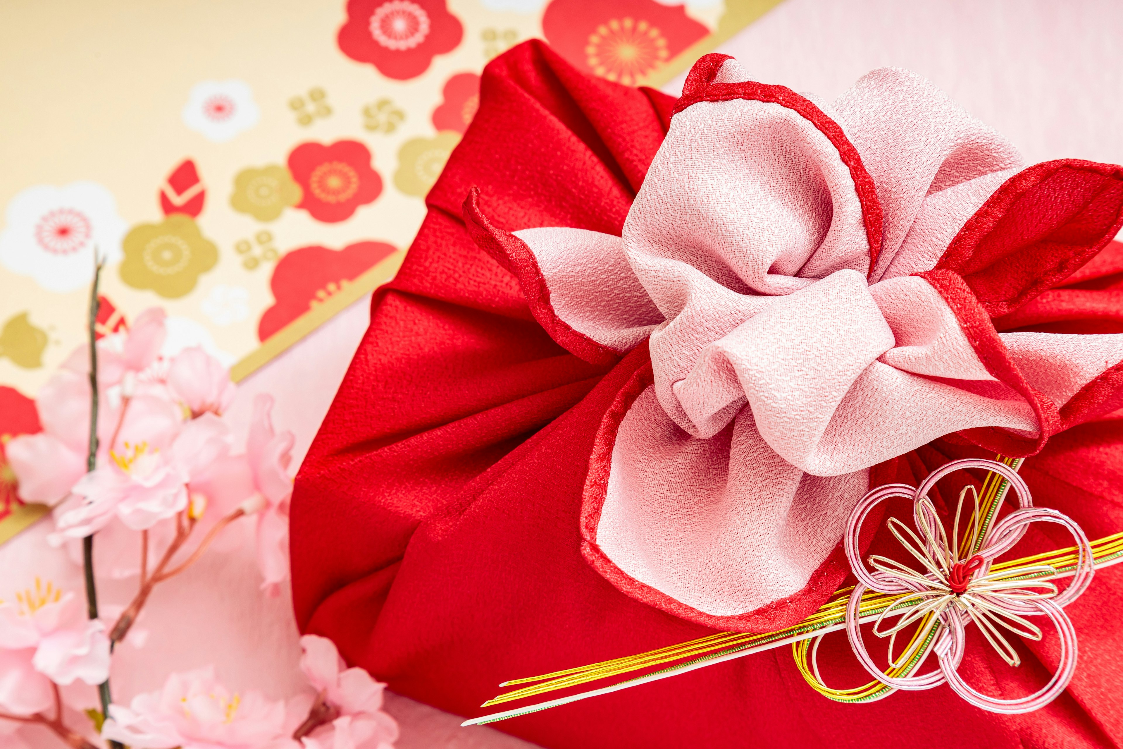 Japanese-style gift wrapped in red fabric with a pink ribbon