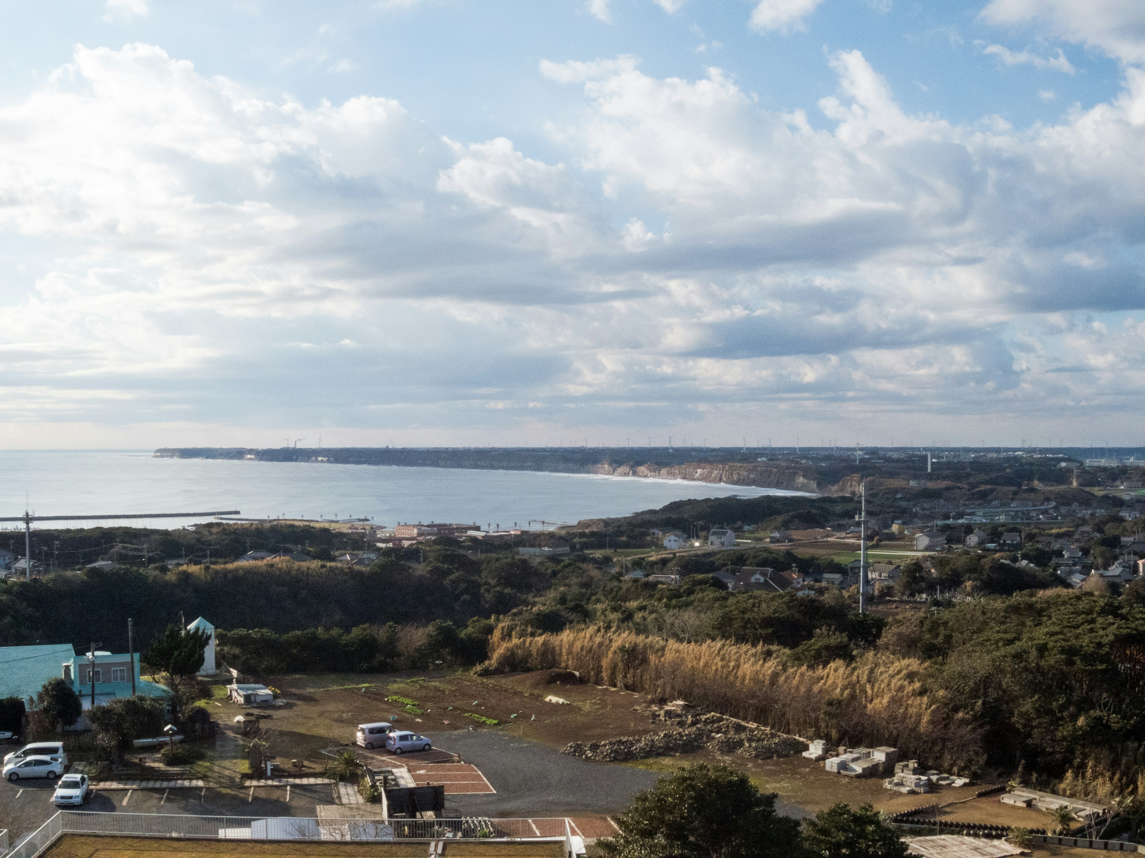 Landscape featuring a coastline and a cloudy sky