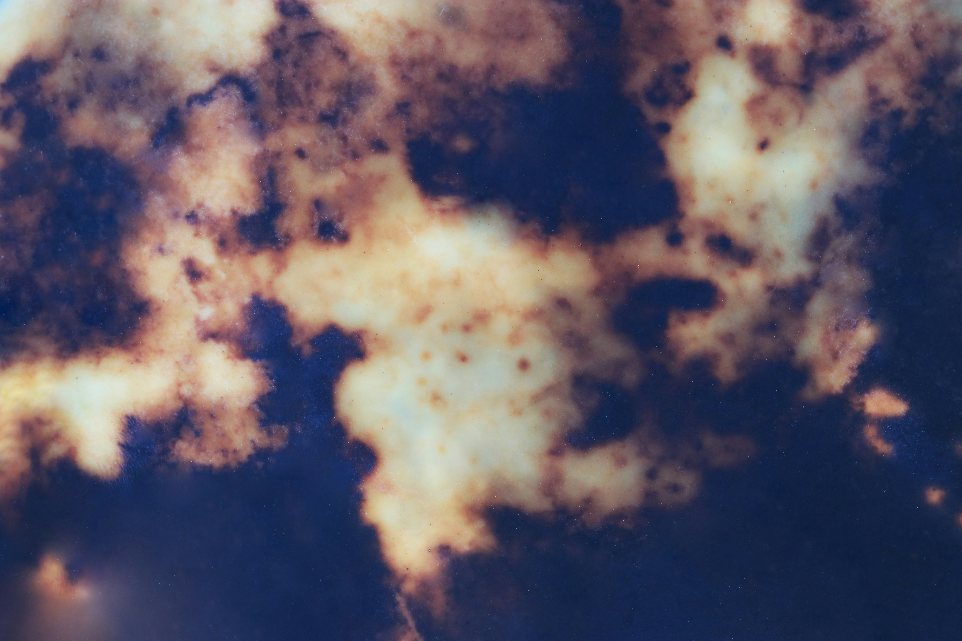 Abstract image with cloud-like patterns in blue and brown hues