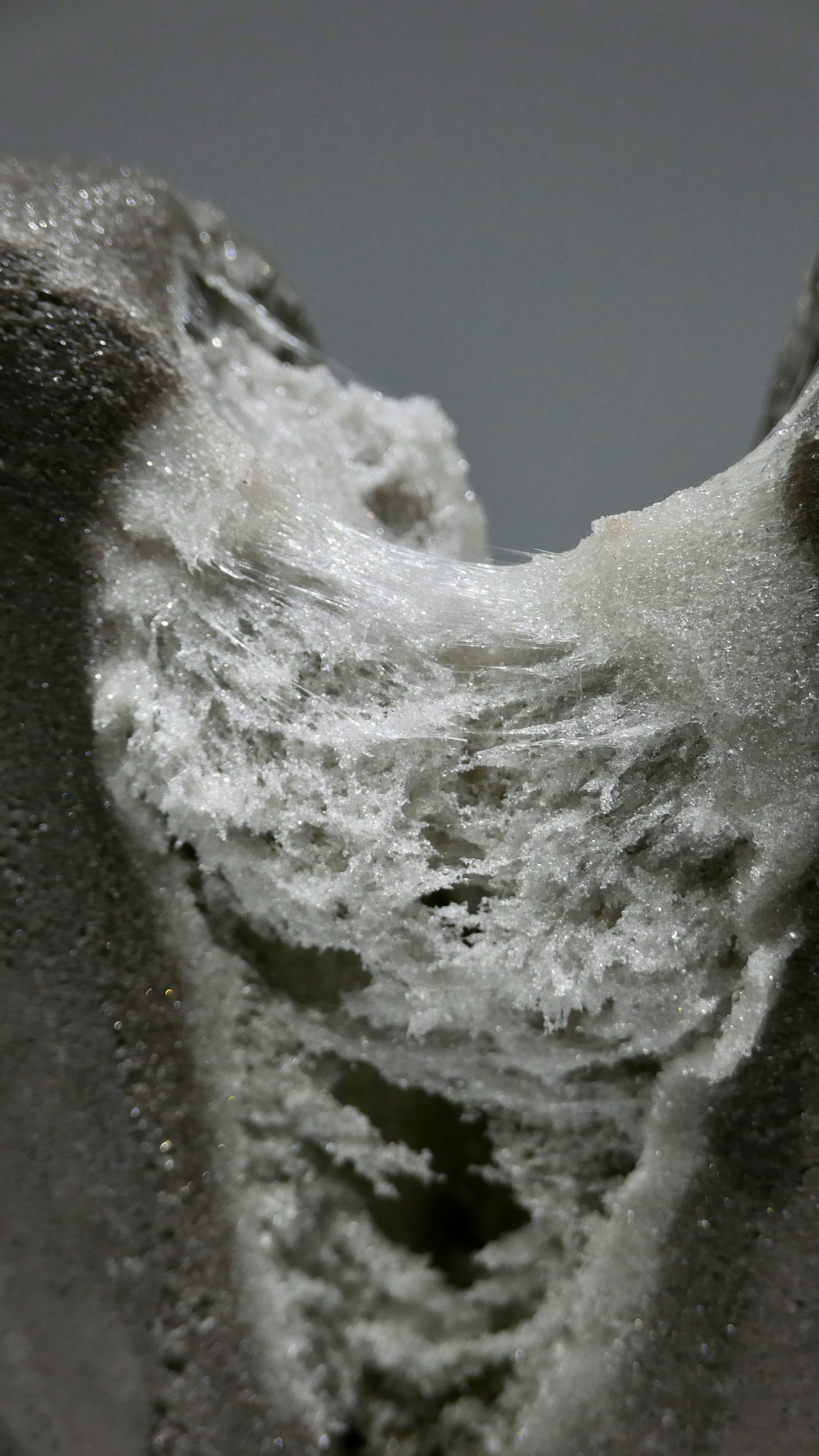 Close-up of a textured material showing white powder and intricate details